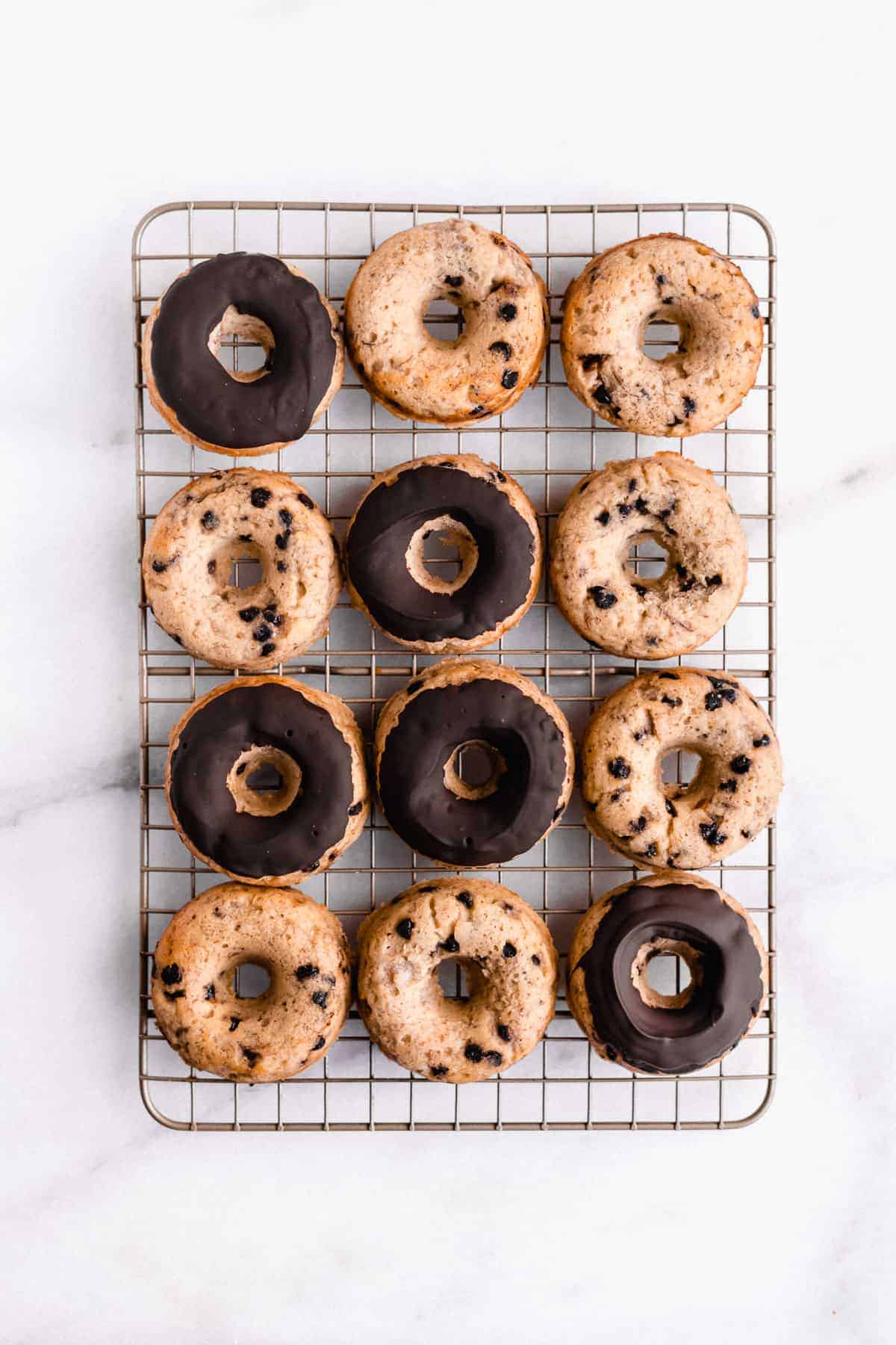 Overhead image of Banana Bread Doughnuts laying on a wire cooling rack.