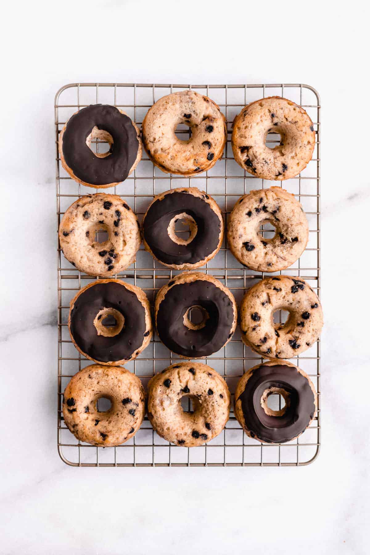 Overhead image of Banana Bread Doughnuts laying on a wire cooling rack.  