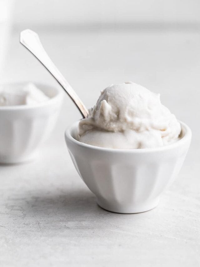 A bowl of vegan vanilla ice cream with a spoon.
