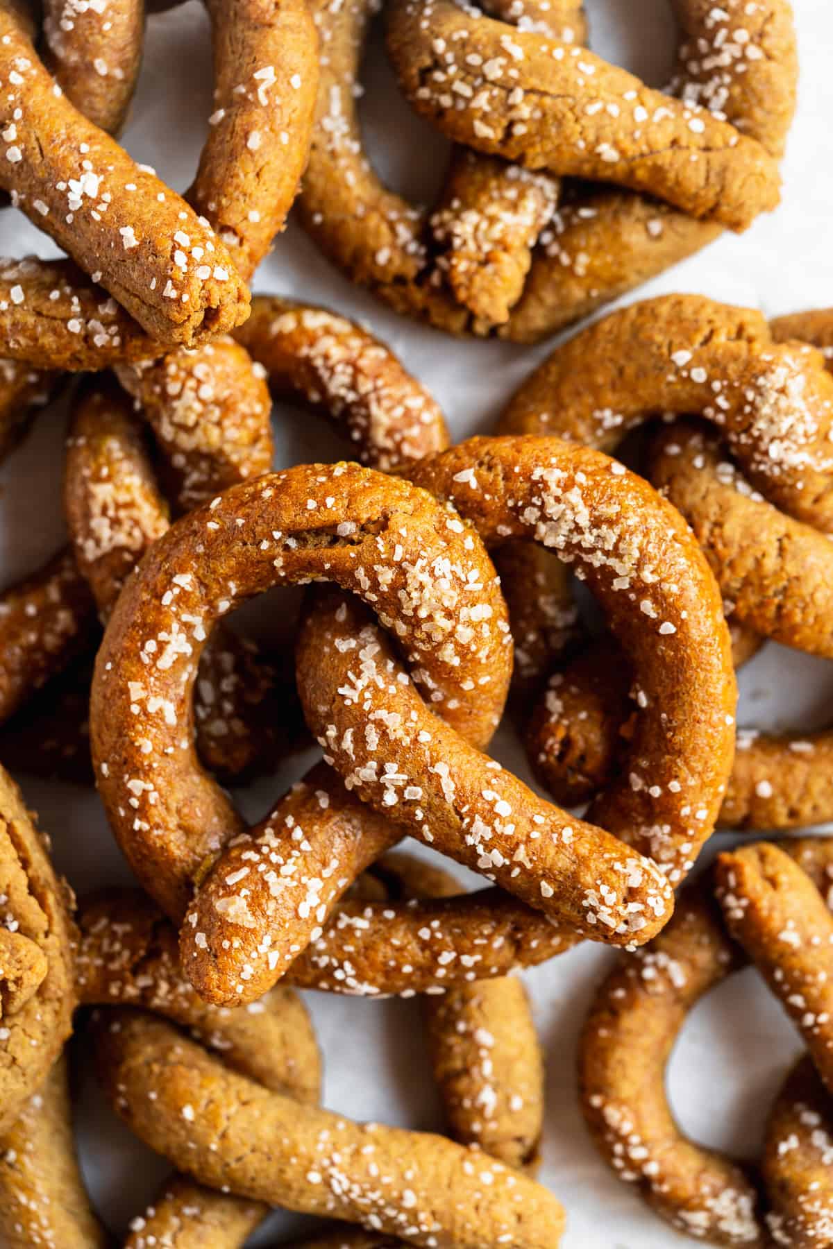 Close up photo of freshly baked Gluten-free Soft Pretzels sitting on parchment paper.