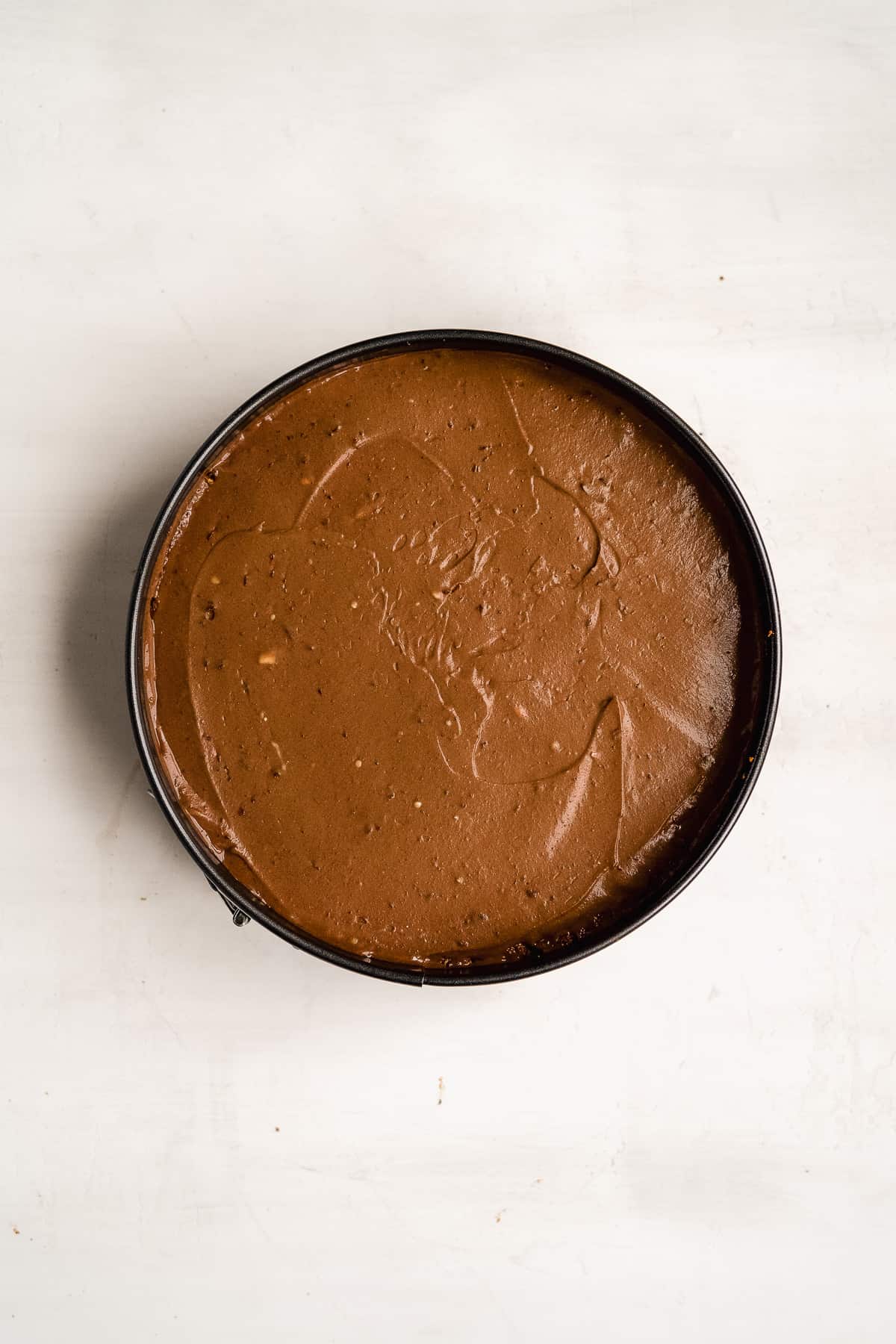 Chocolate cheesecake batter poured into a chocolate crust.