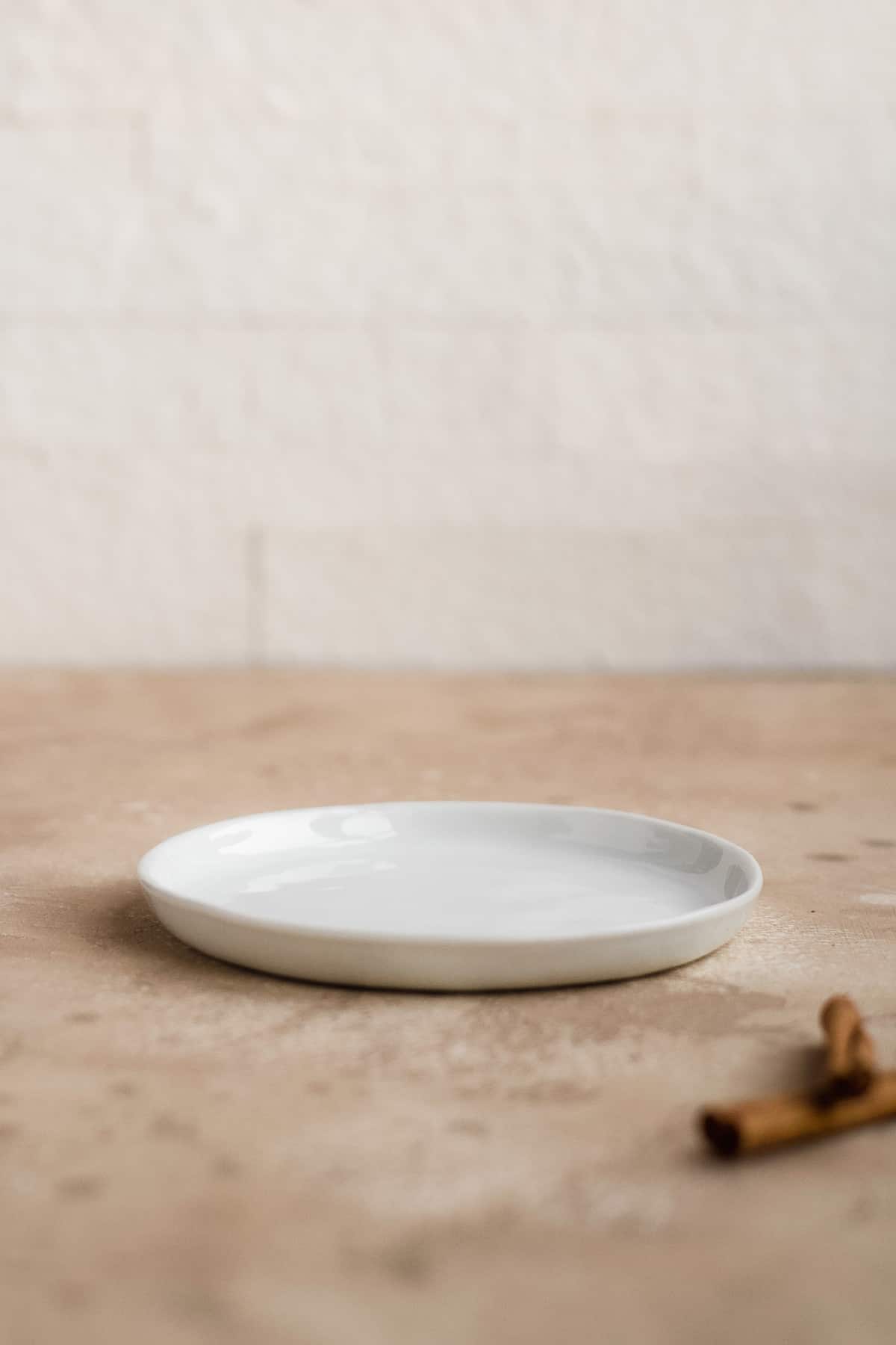 White plate on a brown surface.