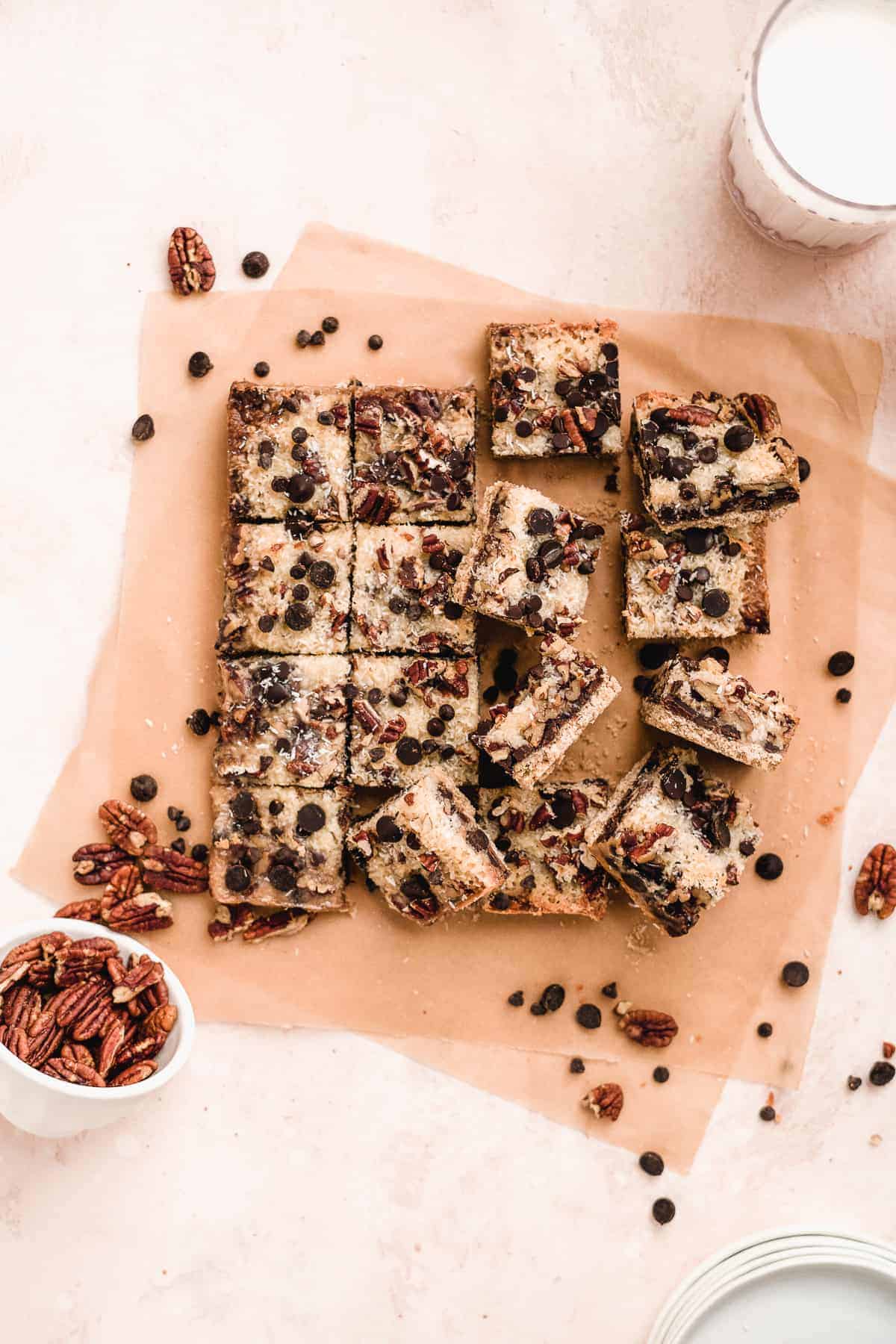 Overhead view of baked Toasted Oat Seven Layer Magic Cookie Bars cut into squares and separated to reveal the delicious side and top views.