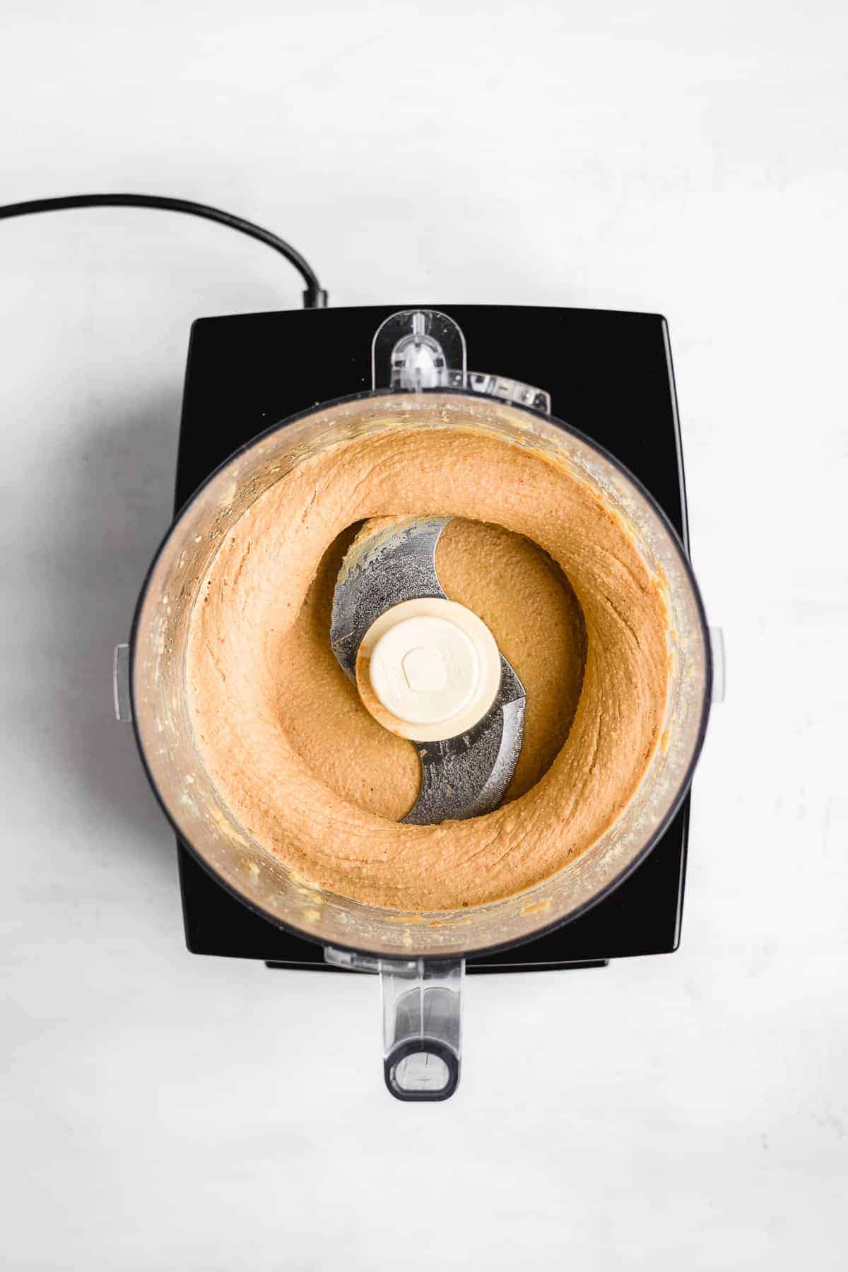 Overhead view of food processor mixing the chocolate chip cookie dough.  