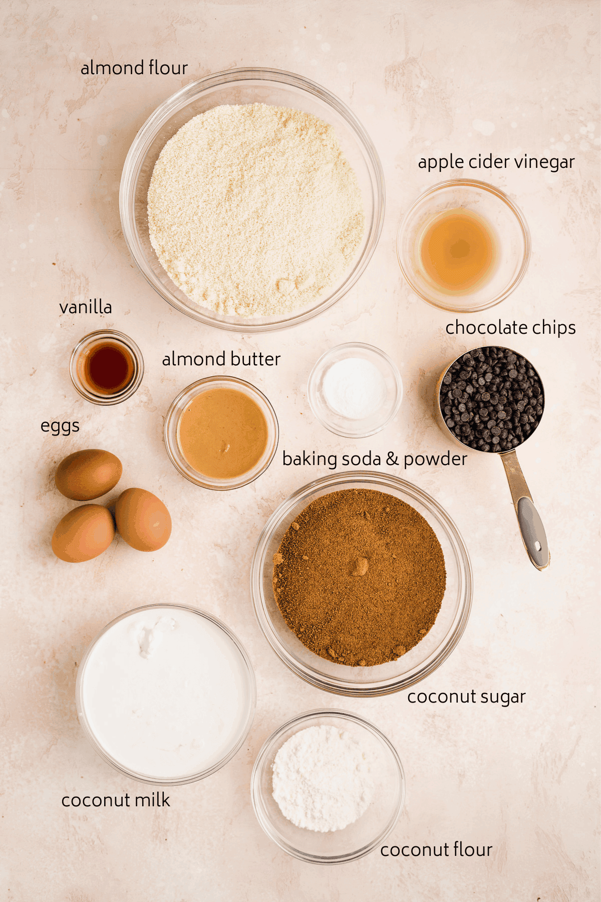 Ingredients list for cookie dough cake on pink surface.
