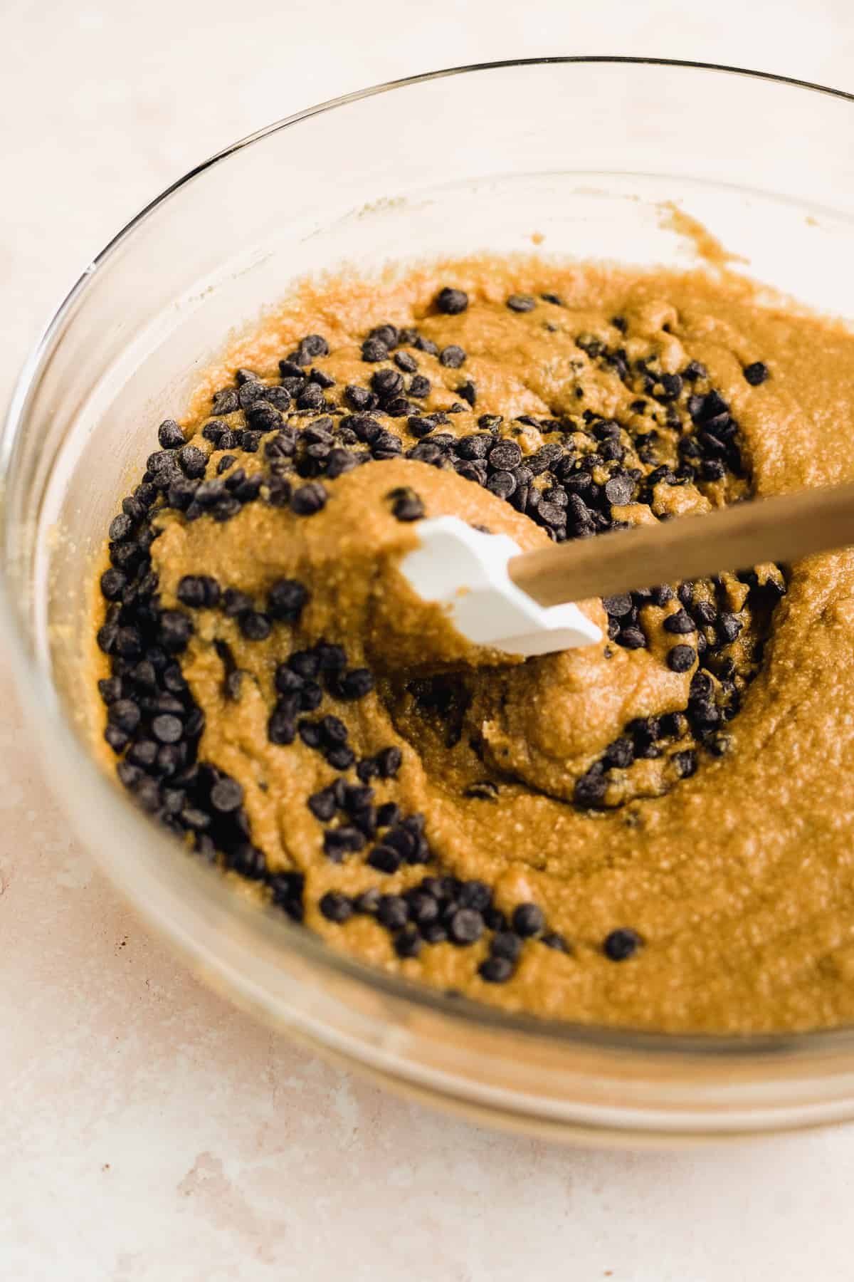 Chocolate chip cookie dough cake batter in a large bowl.