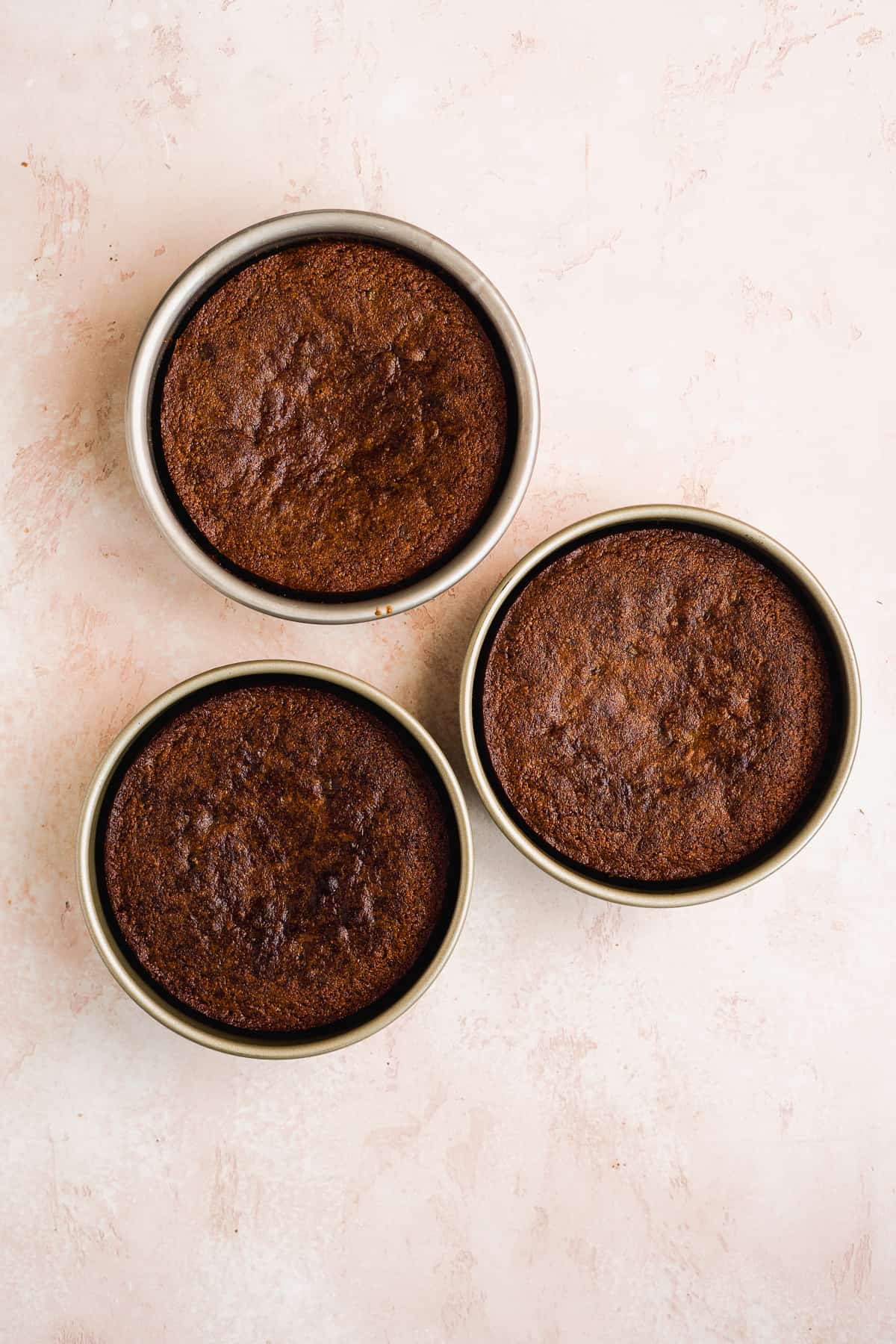 Cookie dough cakes baked in three round pans.