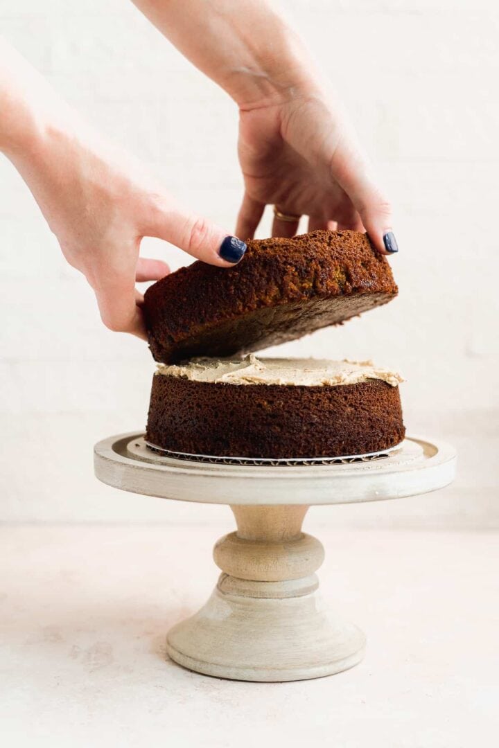 Cake layers being placed on top of one another.