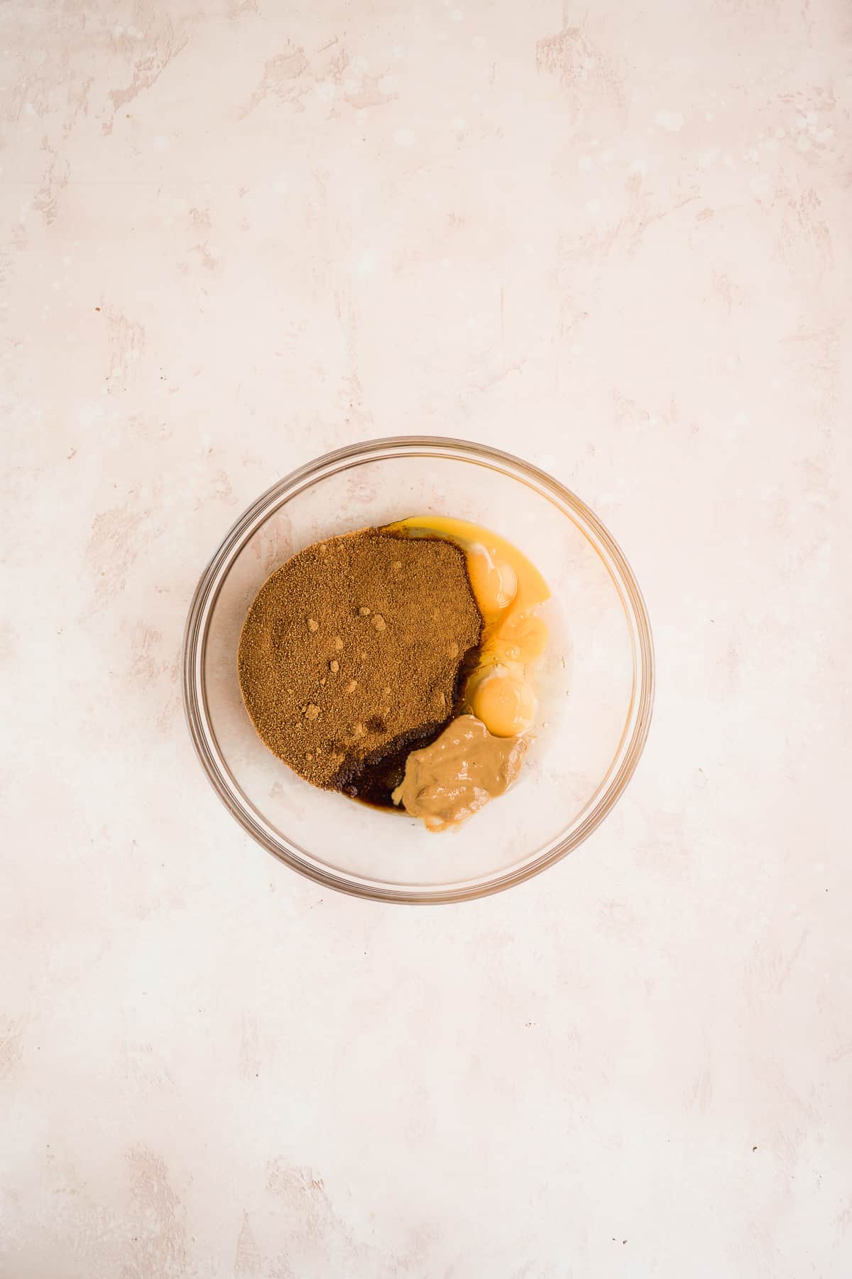 Cookie dough cake ingredients in a glass bowl.