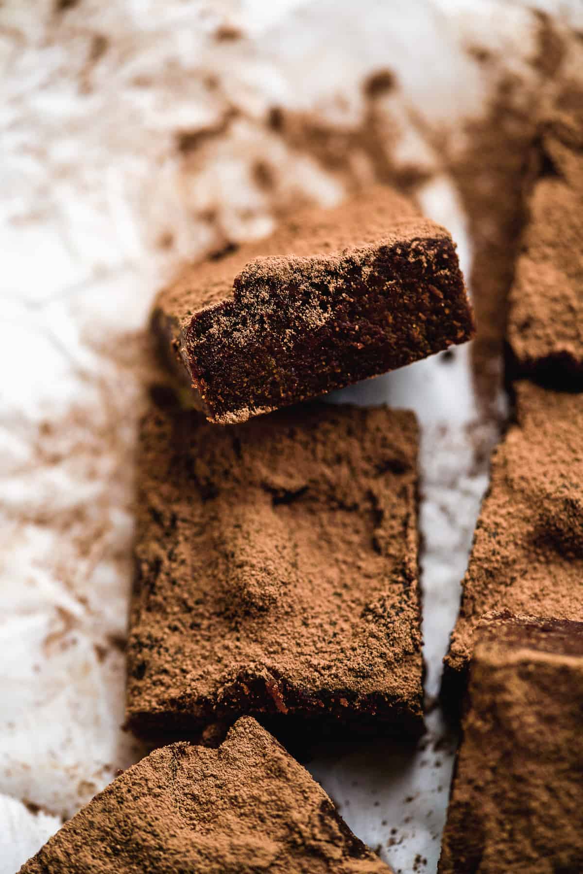 Brownie tilted upwards showing the middle on a white surface.