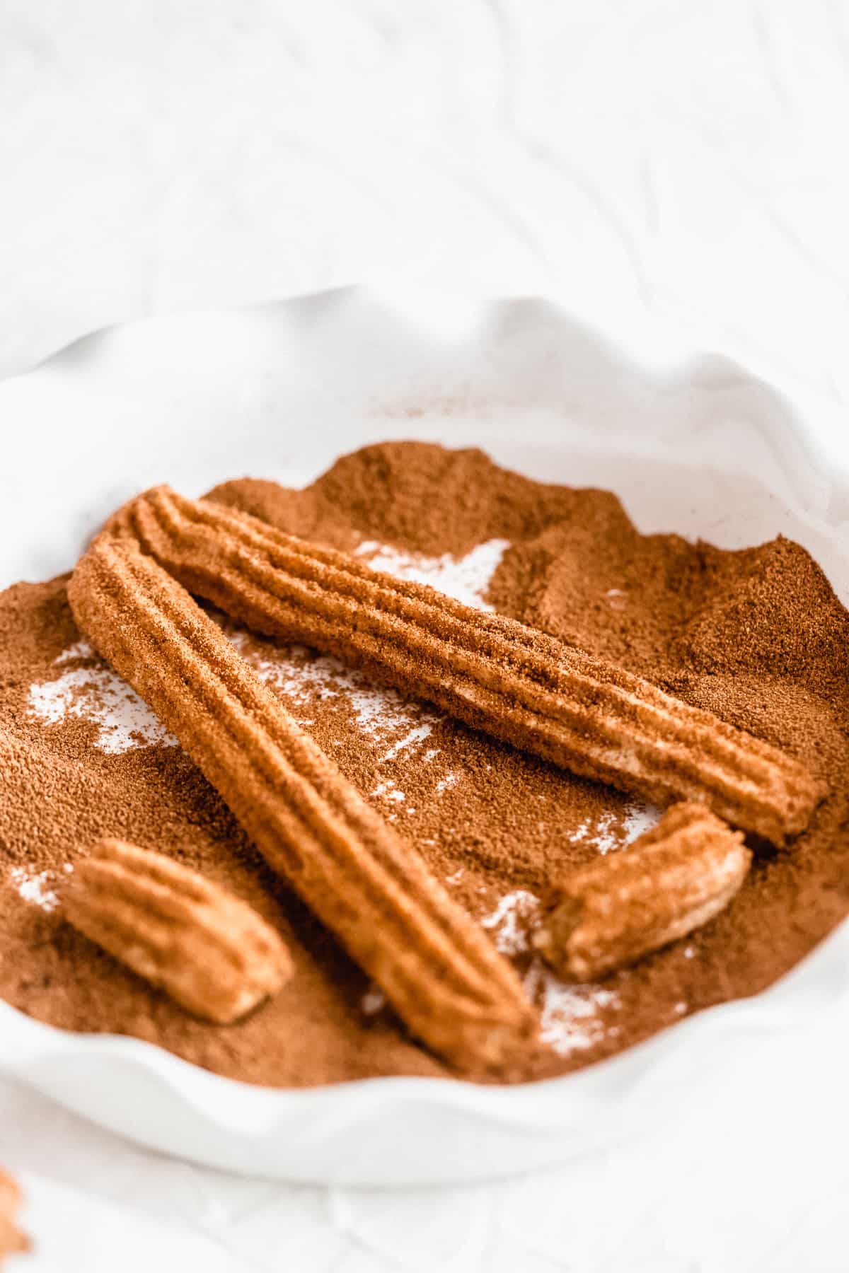 Gluten free churros in a dish.