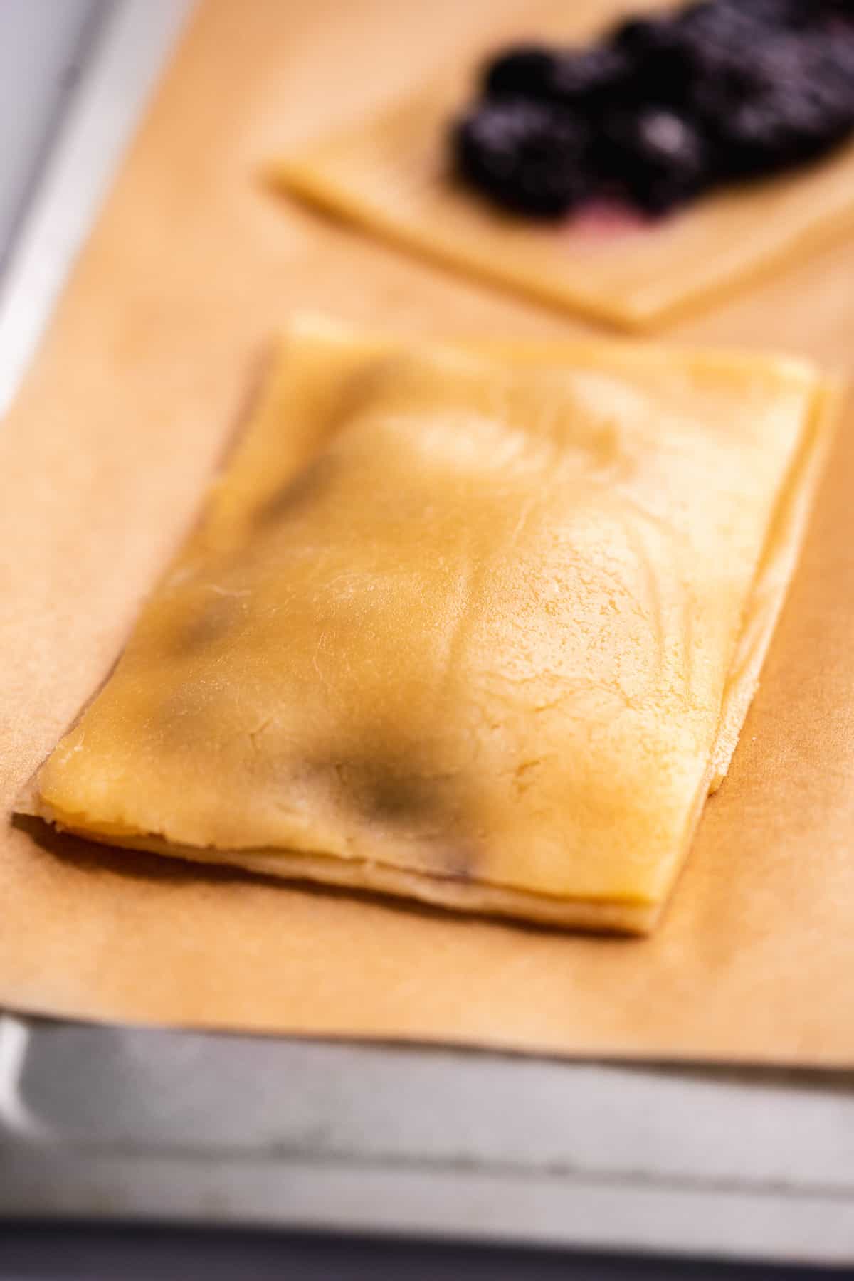 Gluten free pop tart on a baking sheet about to be baked.