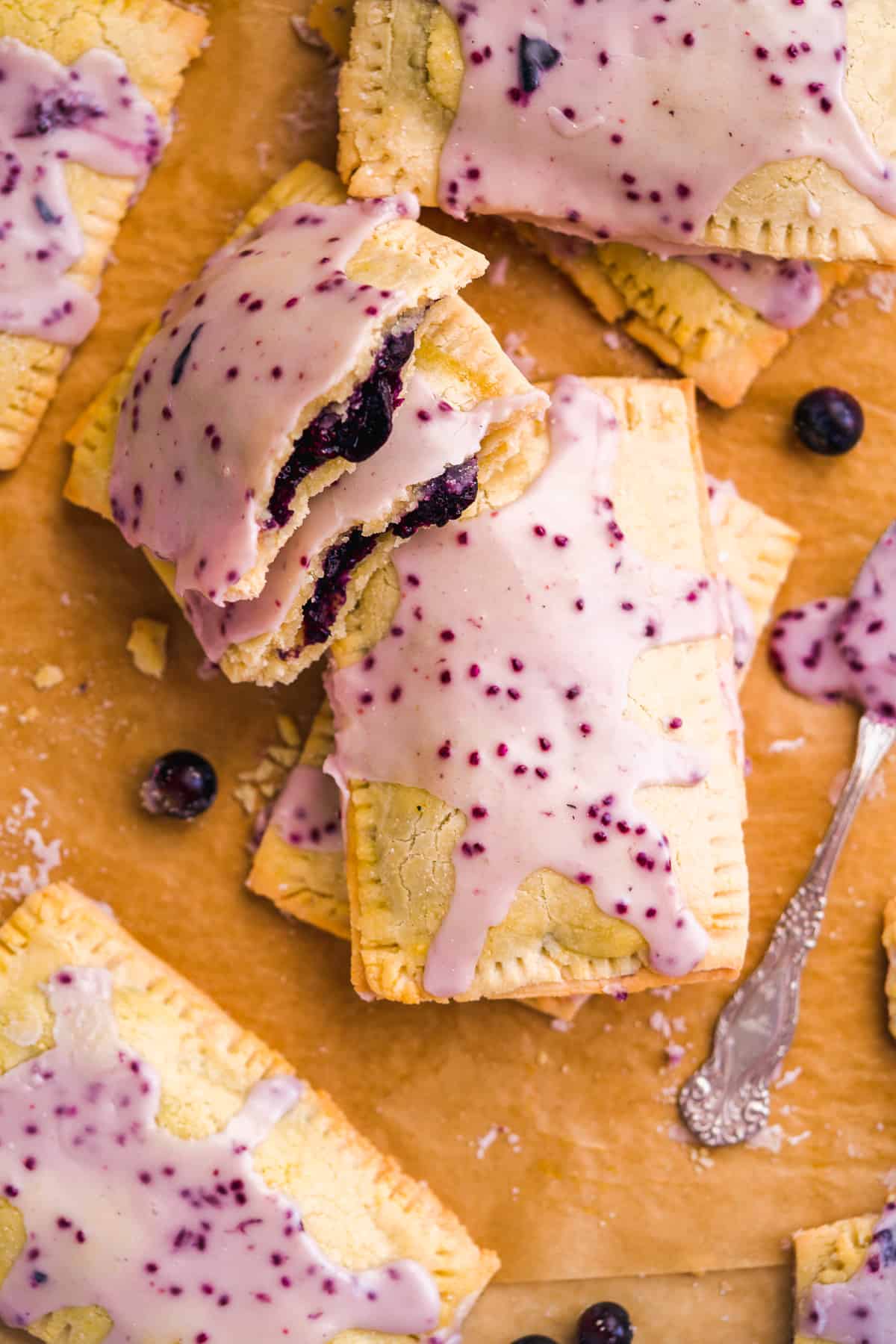 Blueberry pop tarts with filling on parchment paper.