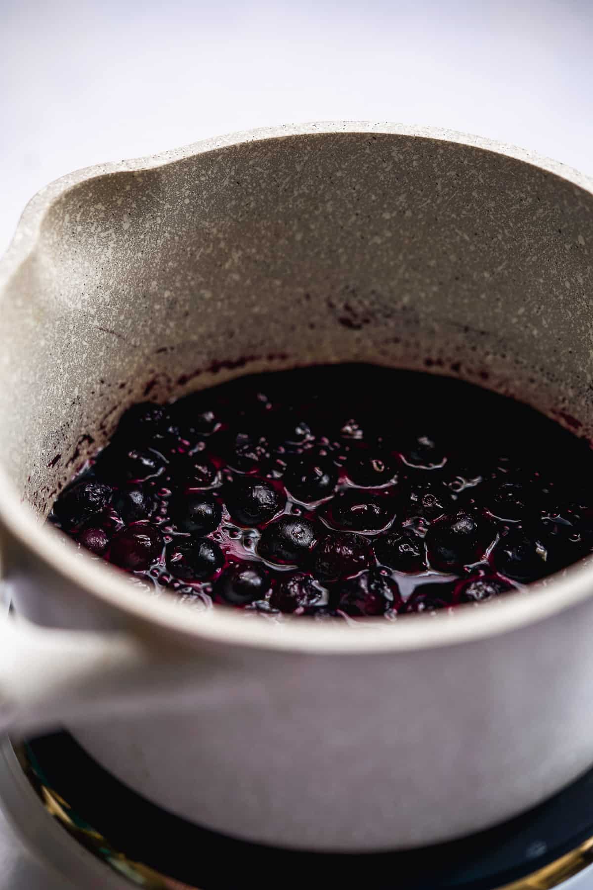 Blueberries cooking in a pot.