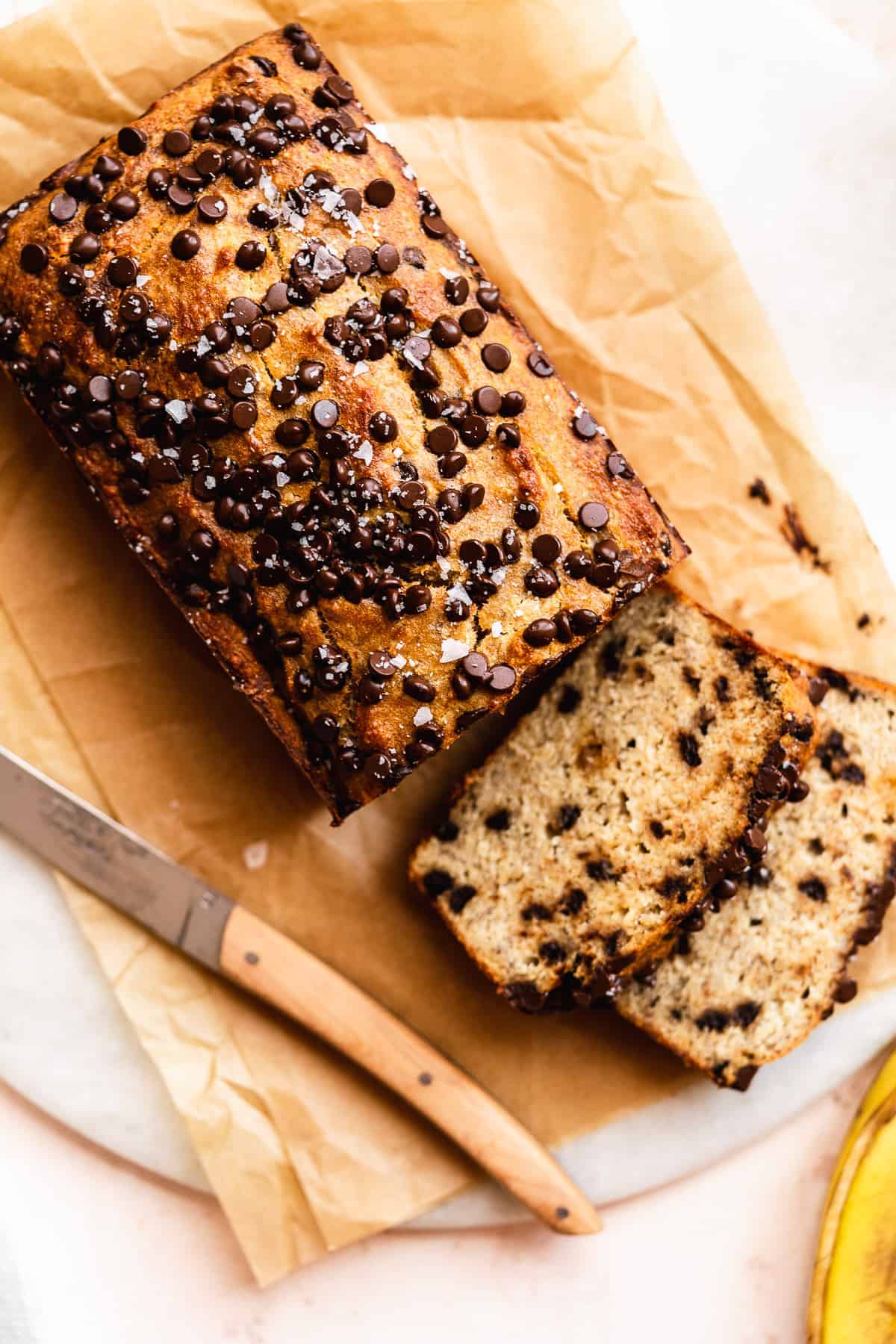 View from above of chocolate chip bread with a few slices laying in front.