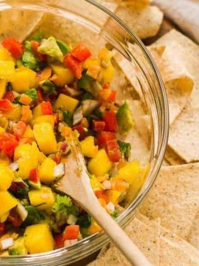 Mango Habanero Salsa with a wooden serving spoon.