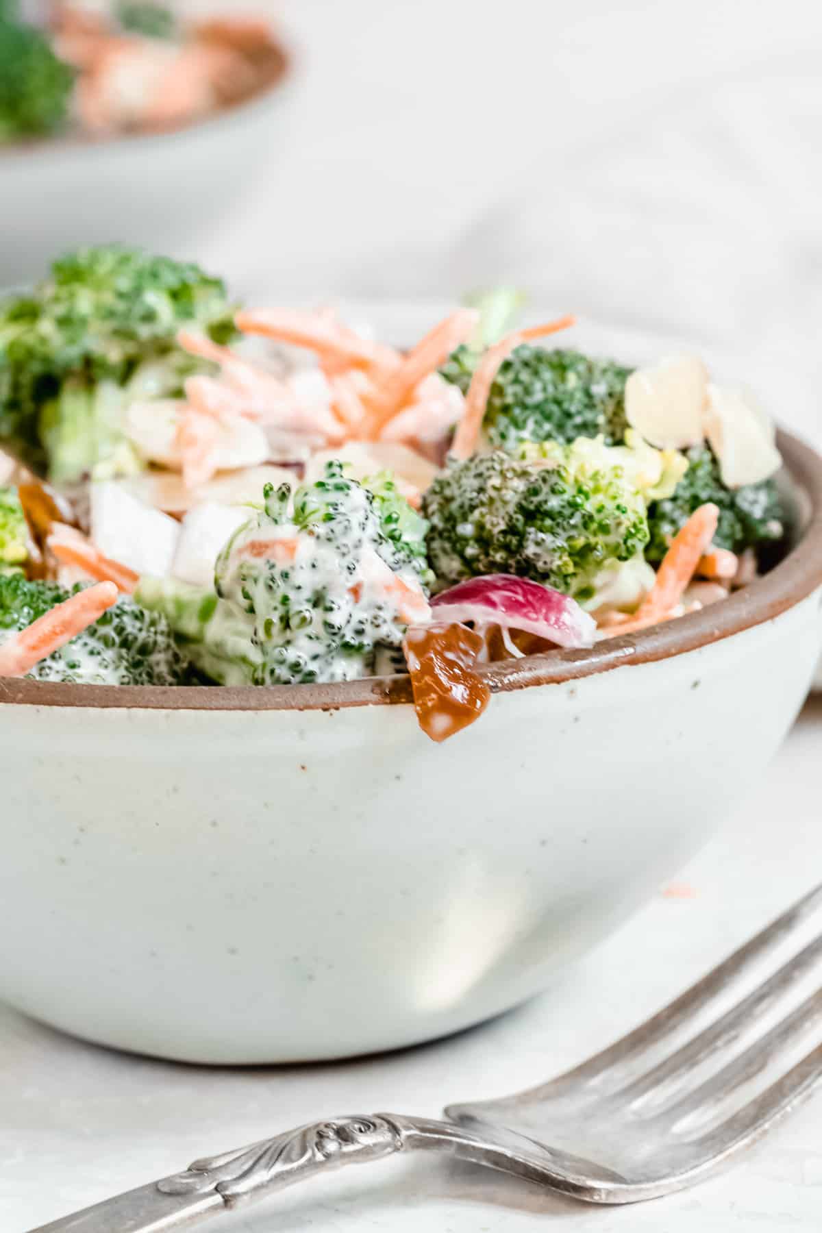 Ceramic bowl with broccoli and carrot  mixture.