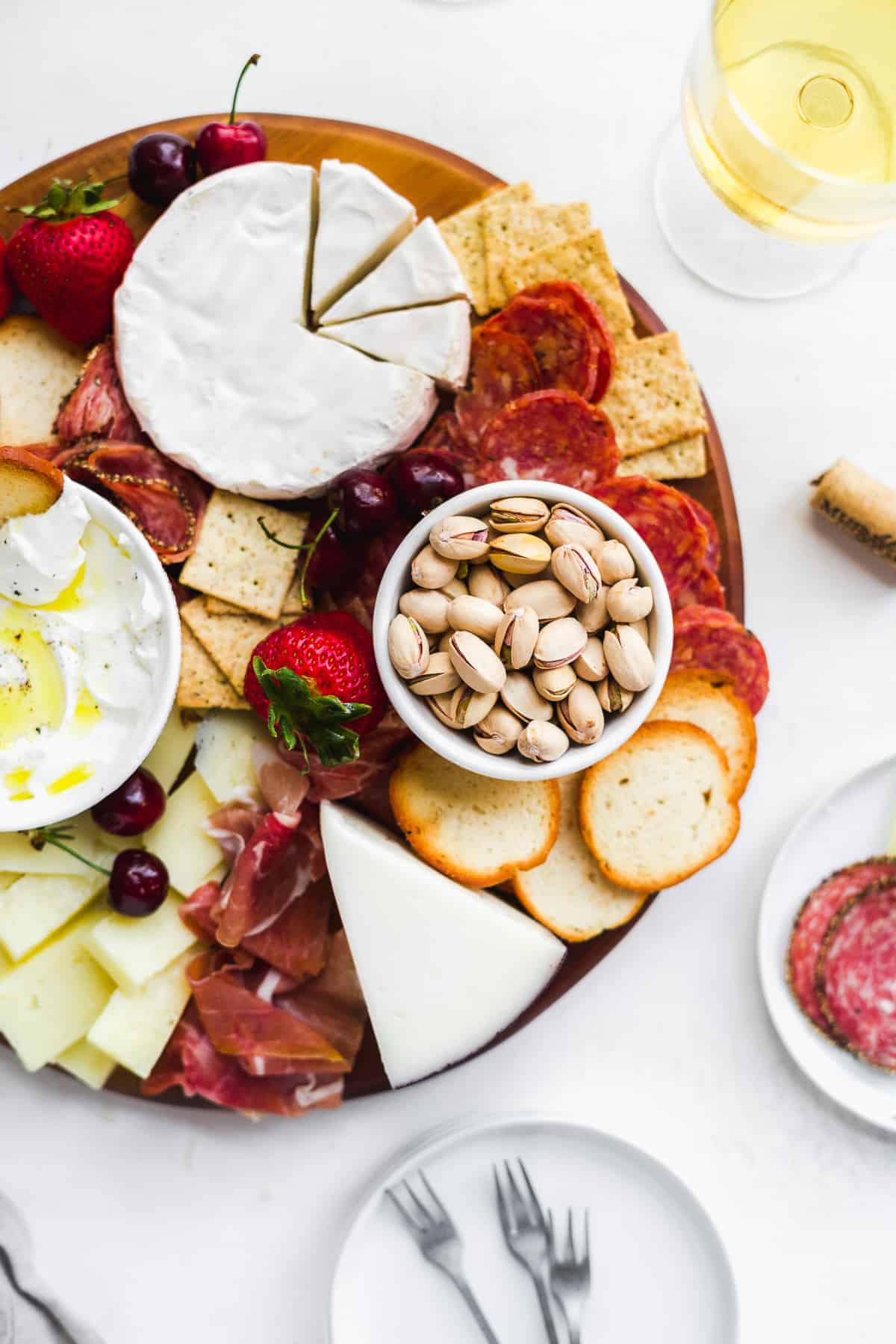 Cheese board with charcuterie and wine.