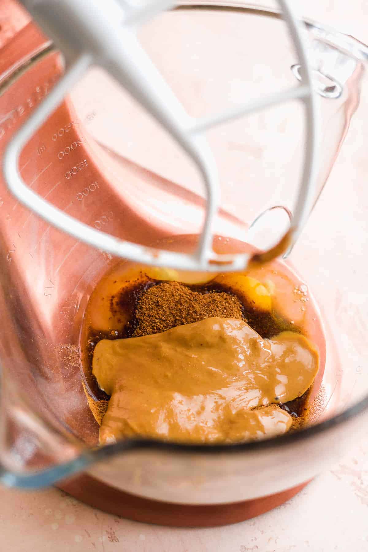 Mixing bowl with peanut butter and other ingredients inside about to be mixed.