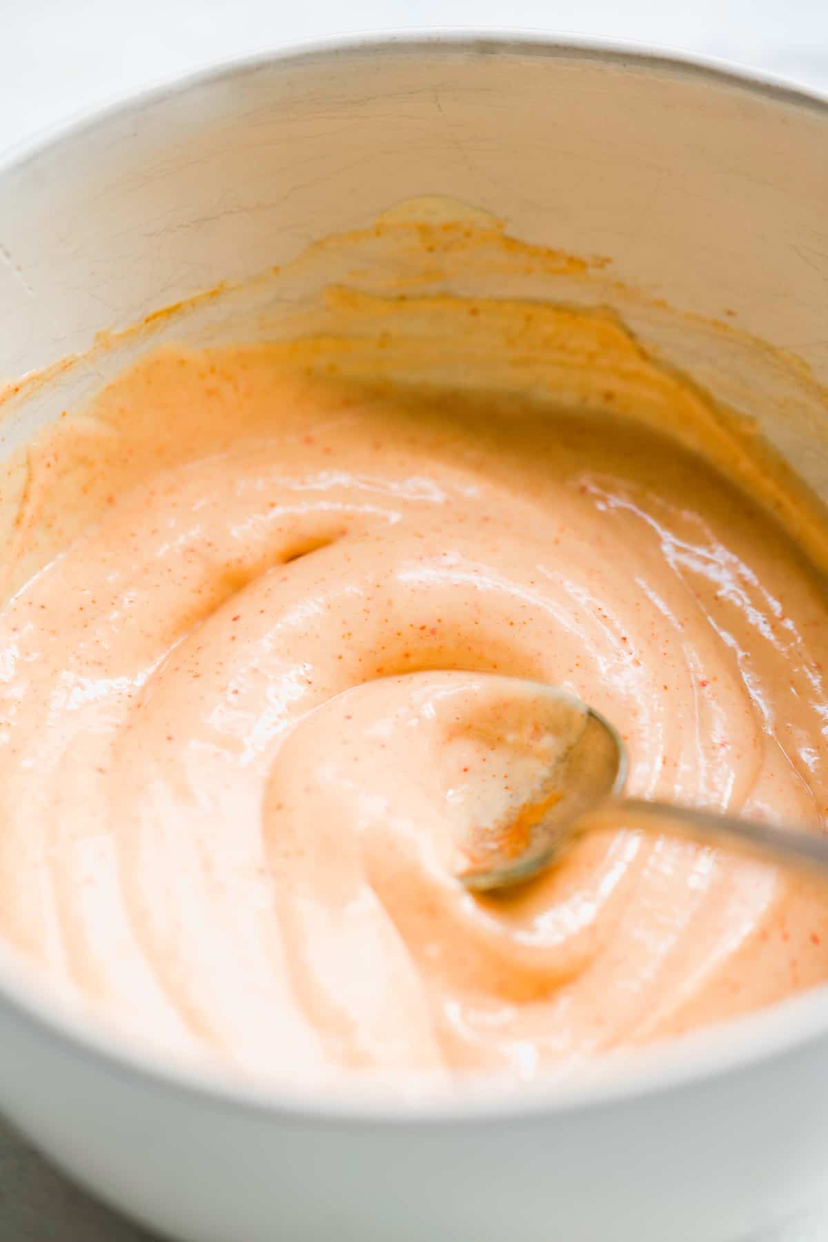 Sauce being mixed in a bowl.