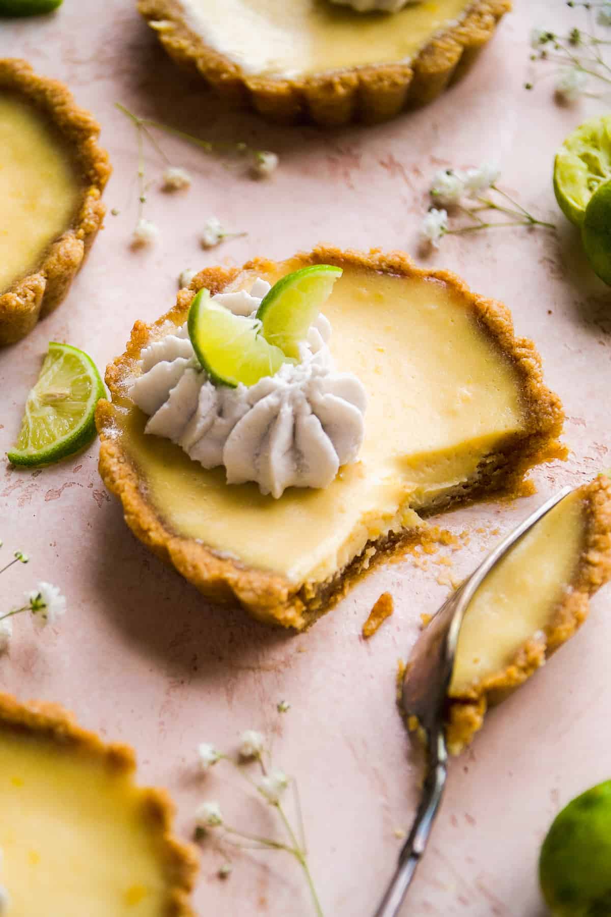 Gluten free key lime pie tart with a fork taking a piece.