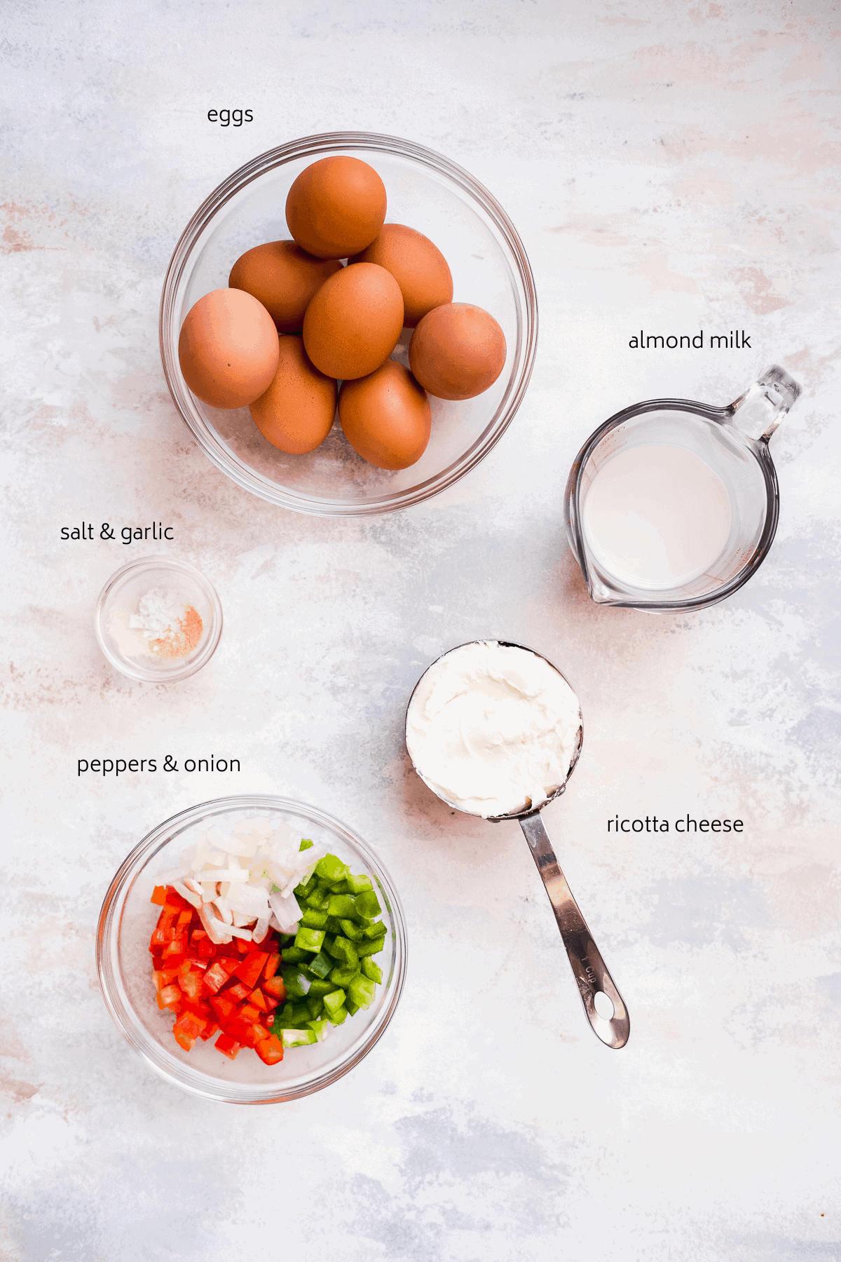 Image of ricotta egg bite ingredients on a surface with black labels.