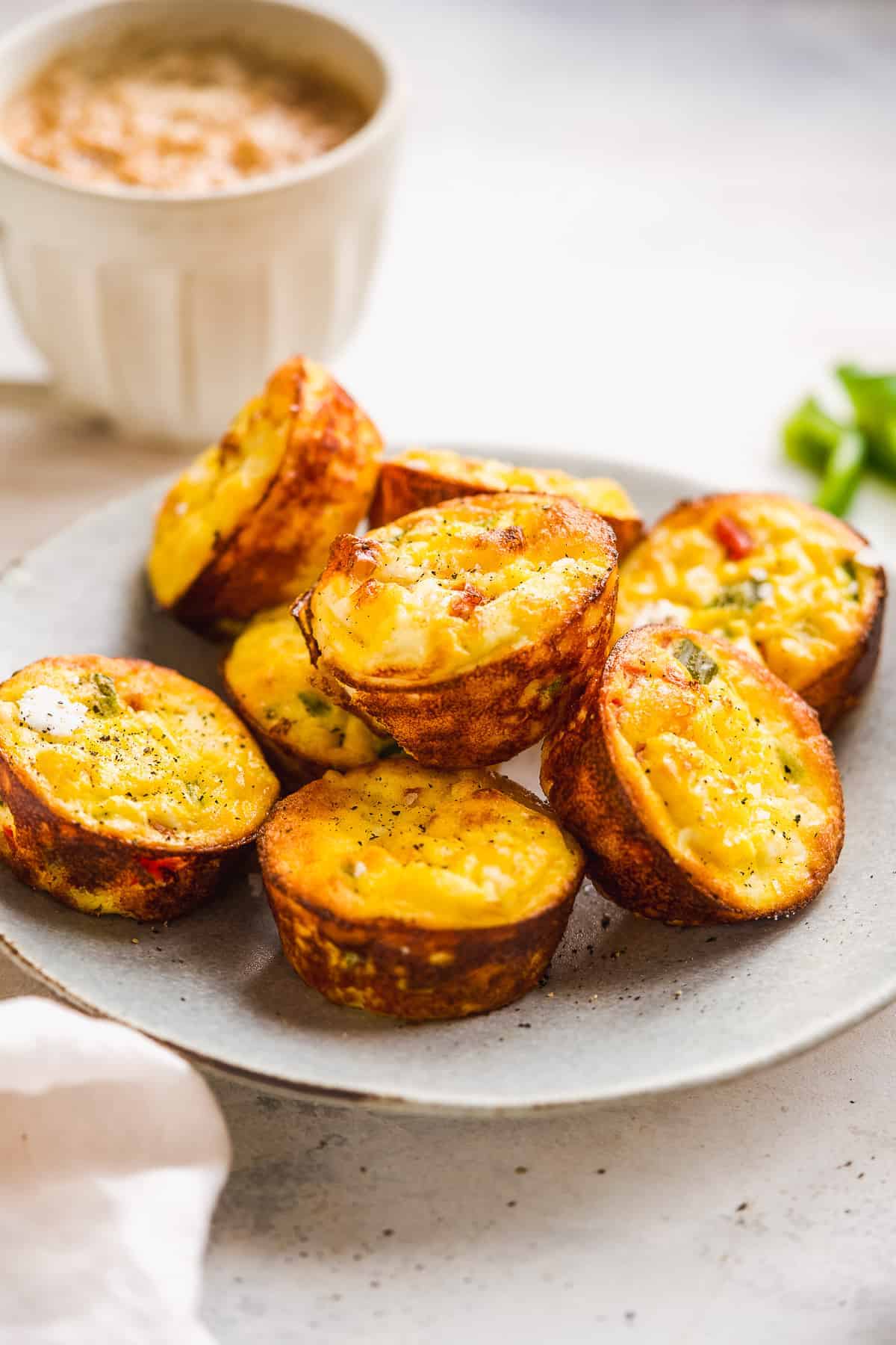 Ricotta egg bites piled on a blue plate.