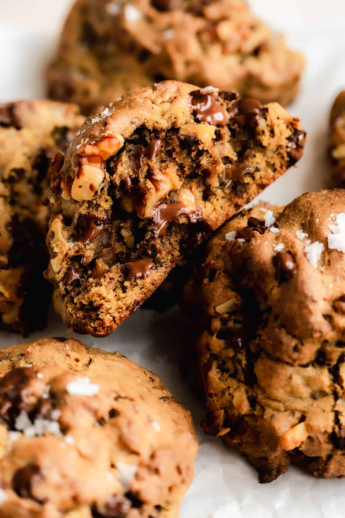 Gluten free Levain bakery cookies cut in half with chocolate chips melted in the middle.