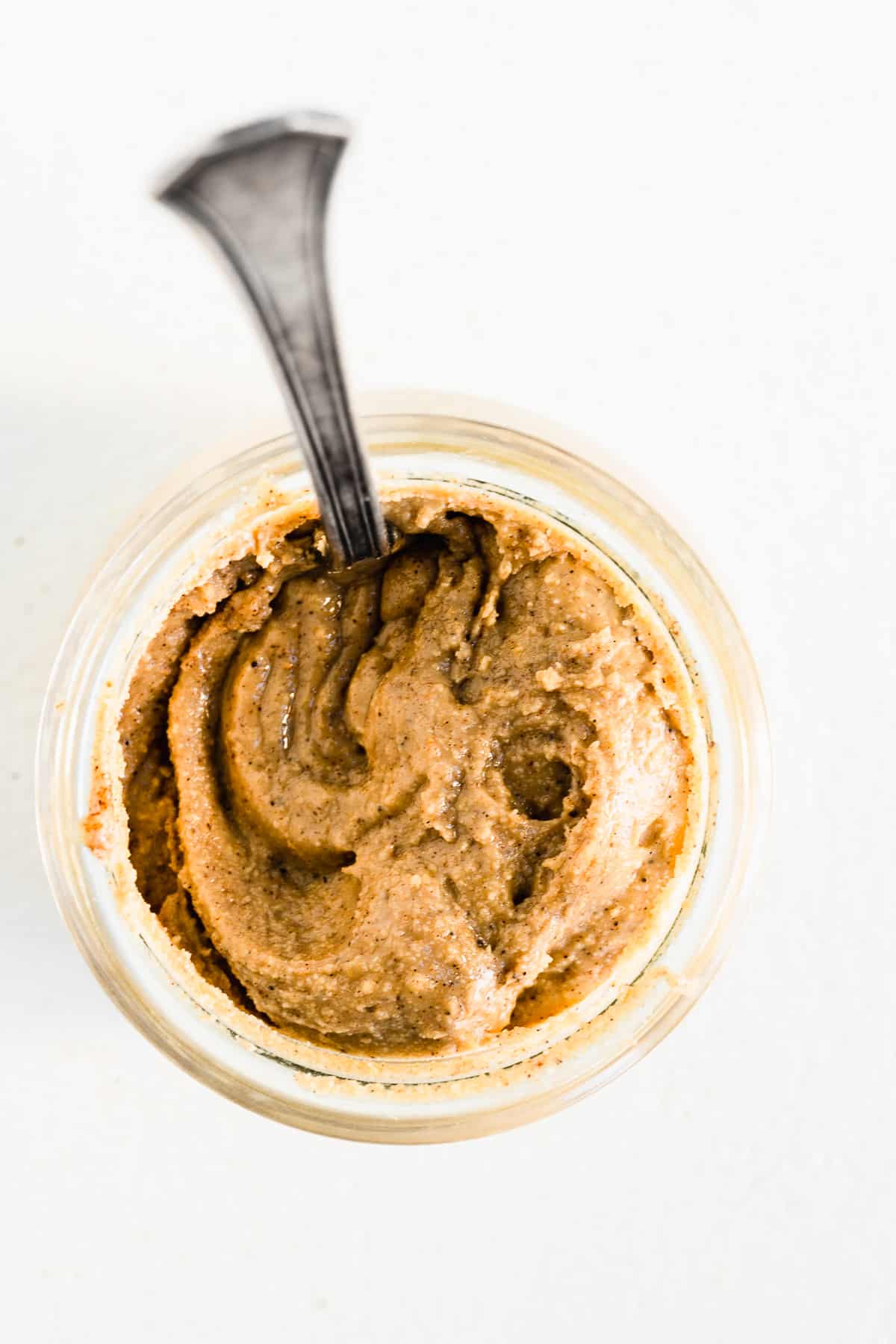 Jar of chia cashew butter with a spoon sticking in the jar.