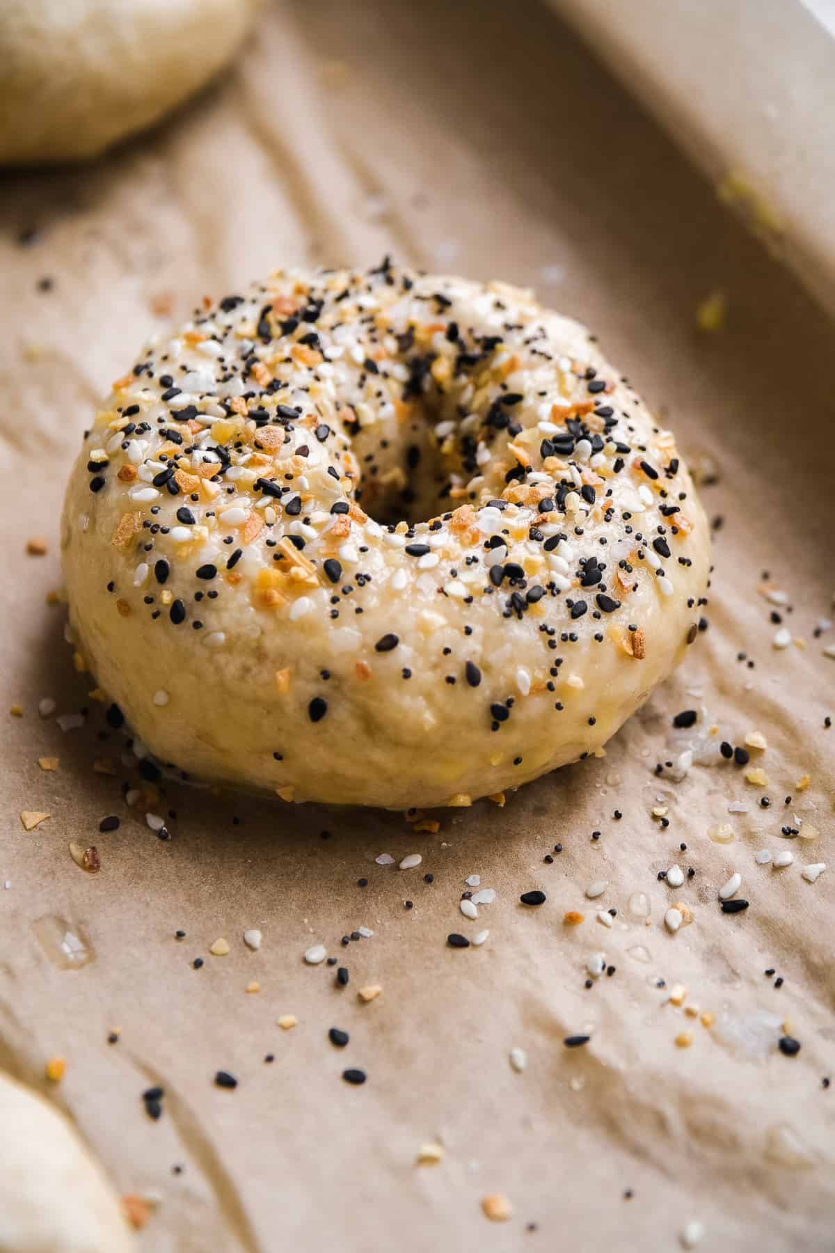 Gluten free everything bagel on a baking sheet about to be baked.