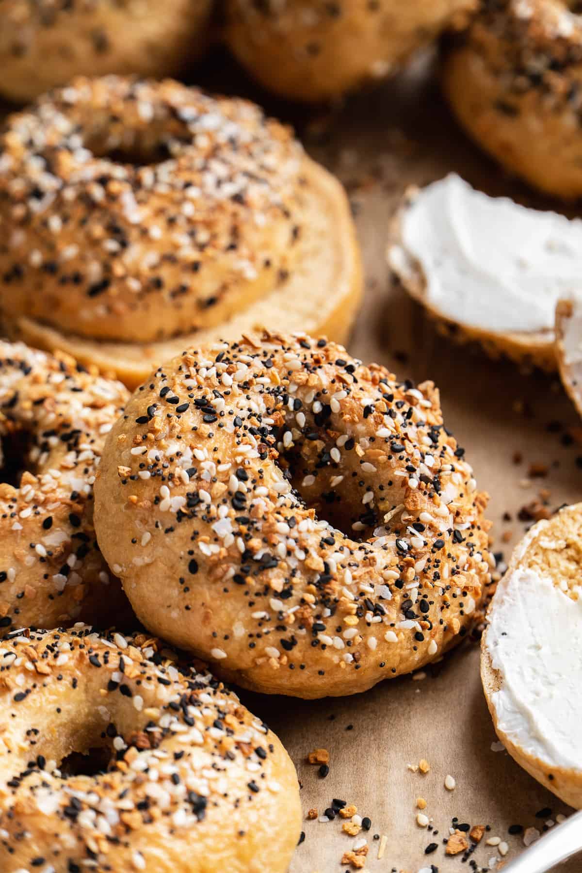 Up close view of a gluten free everything bagel on a baking sheet.