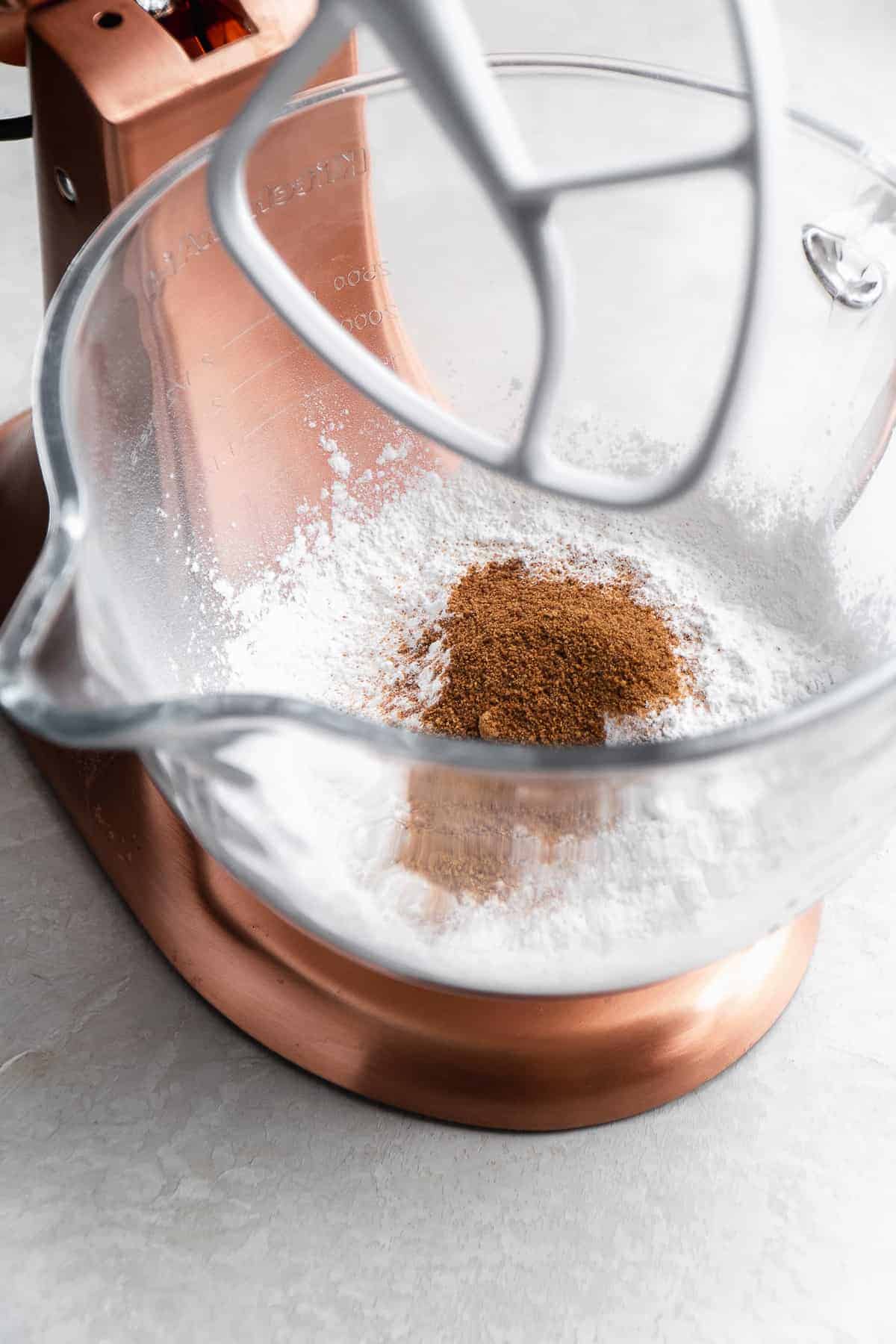 Glass mixing bowl with dry ingredients inside about to be mixed.