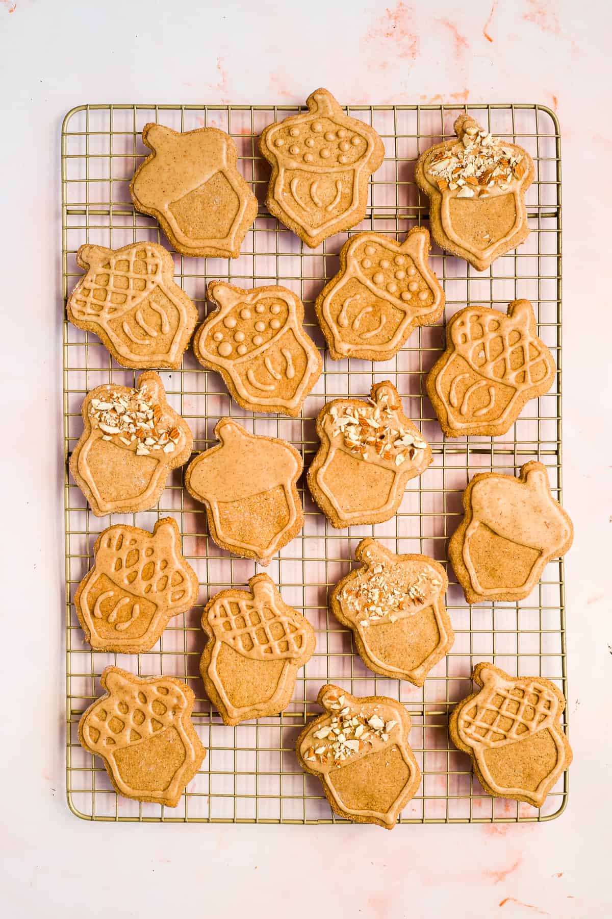 Overhead photo of a full batch of freshly baked almond flour peanut butter cookies on a  gold cooling rack.