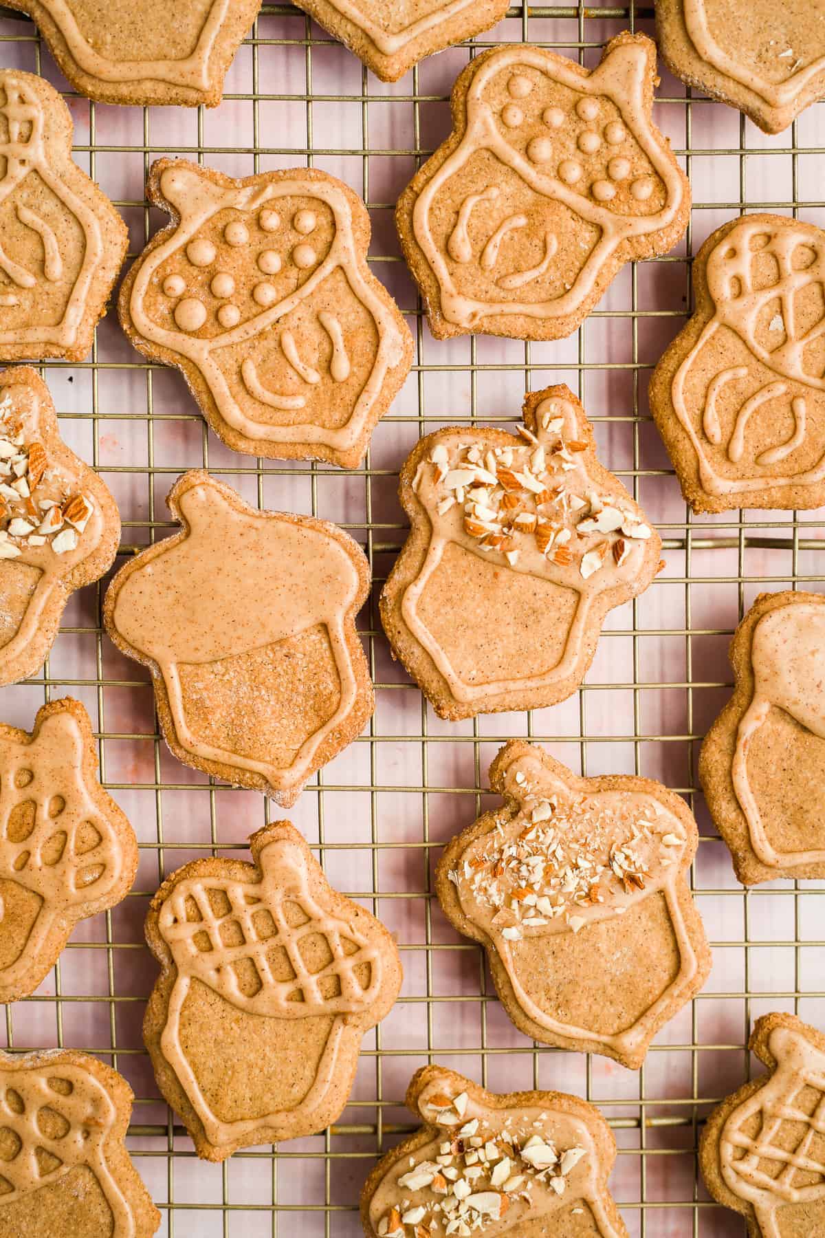 Close up overhead photo of freshly baked and decorated almond flour peanut butter cookies on a cooling rack.