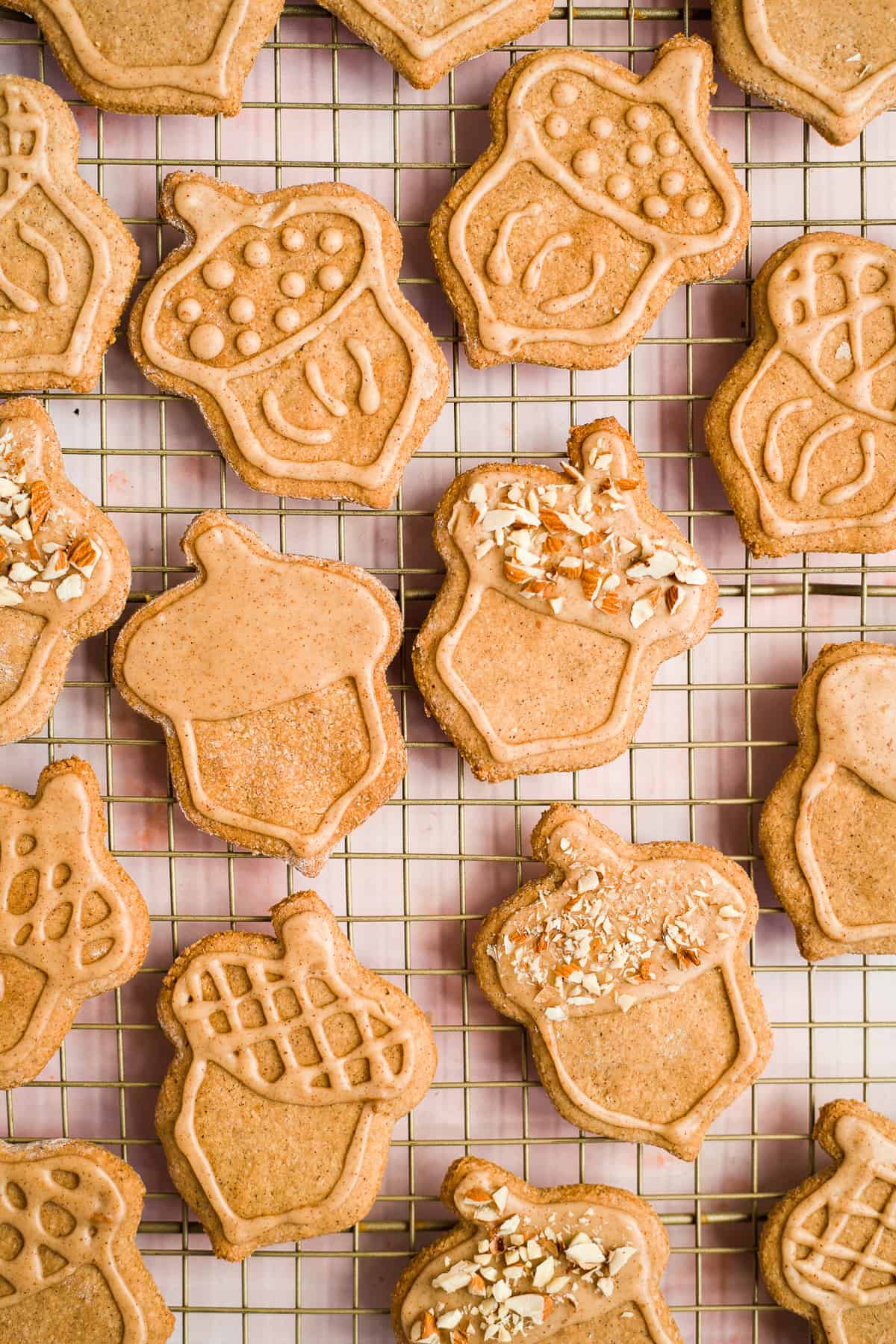 Close up overhead photo of freshly baked and decorated almond flour peanut butter cookies on a cooling rack.  