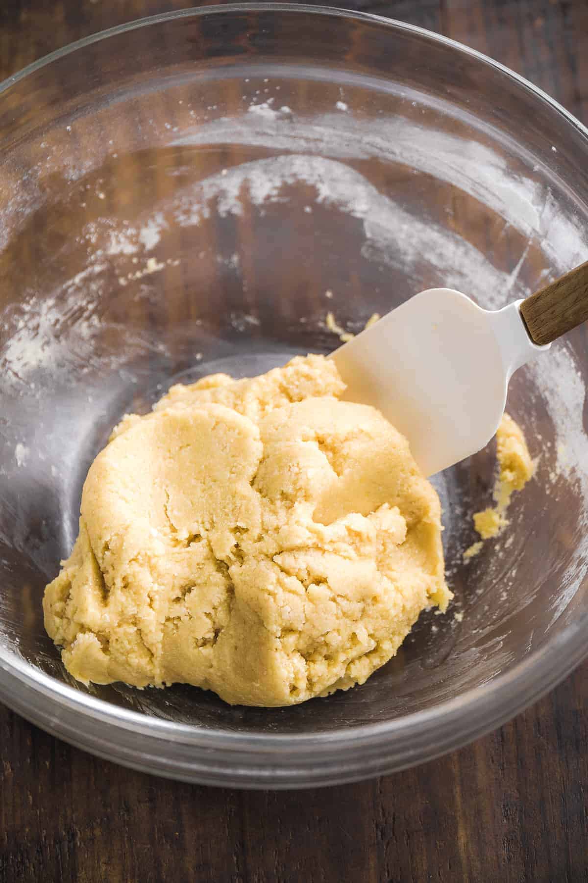 Gluten free sugar cookie dough in a glass bowl.