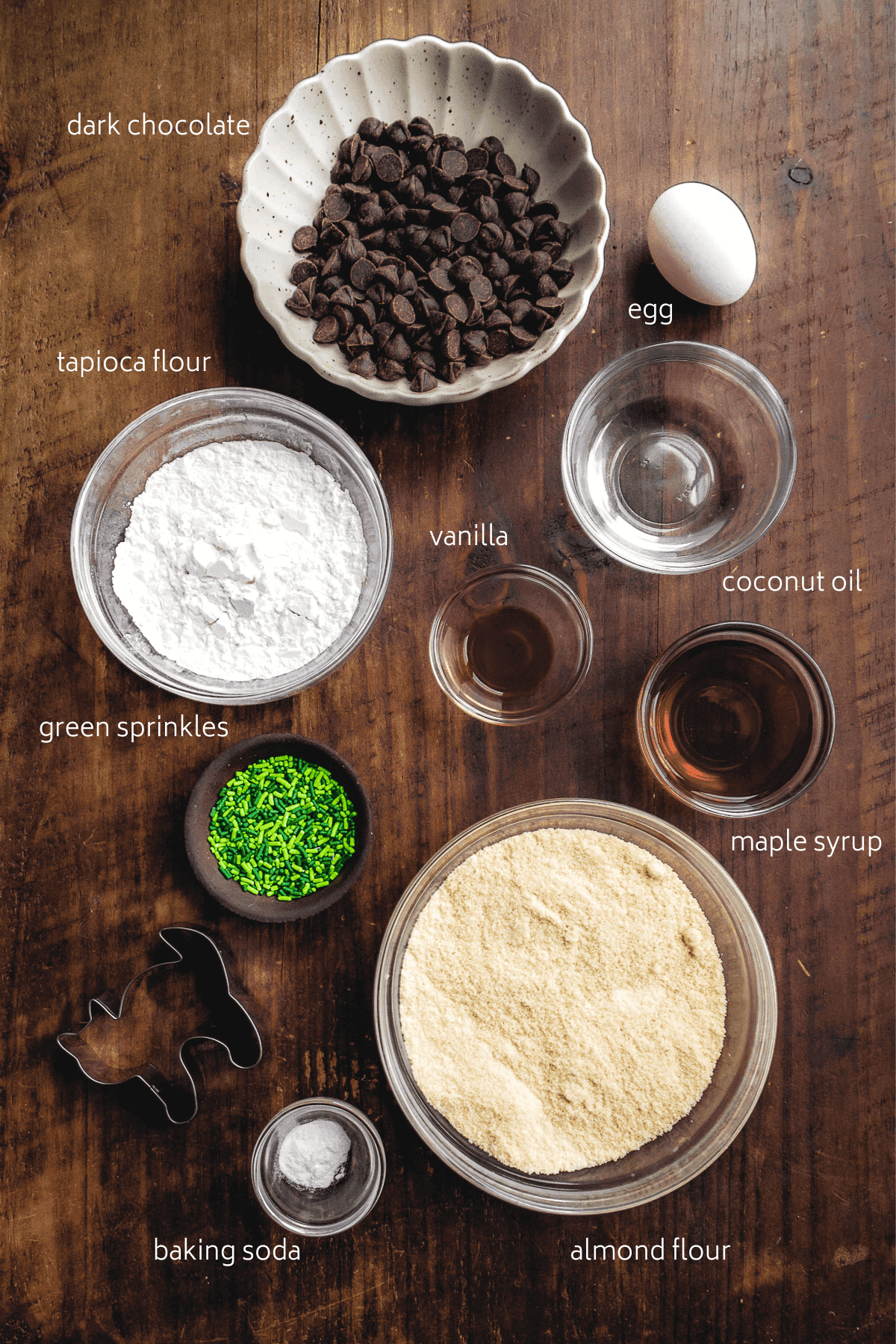 Image of gluten free halloween cookie ingredients on a wooden surface with white labels.