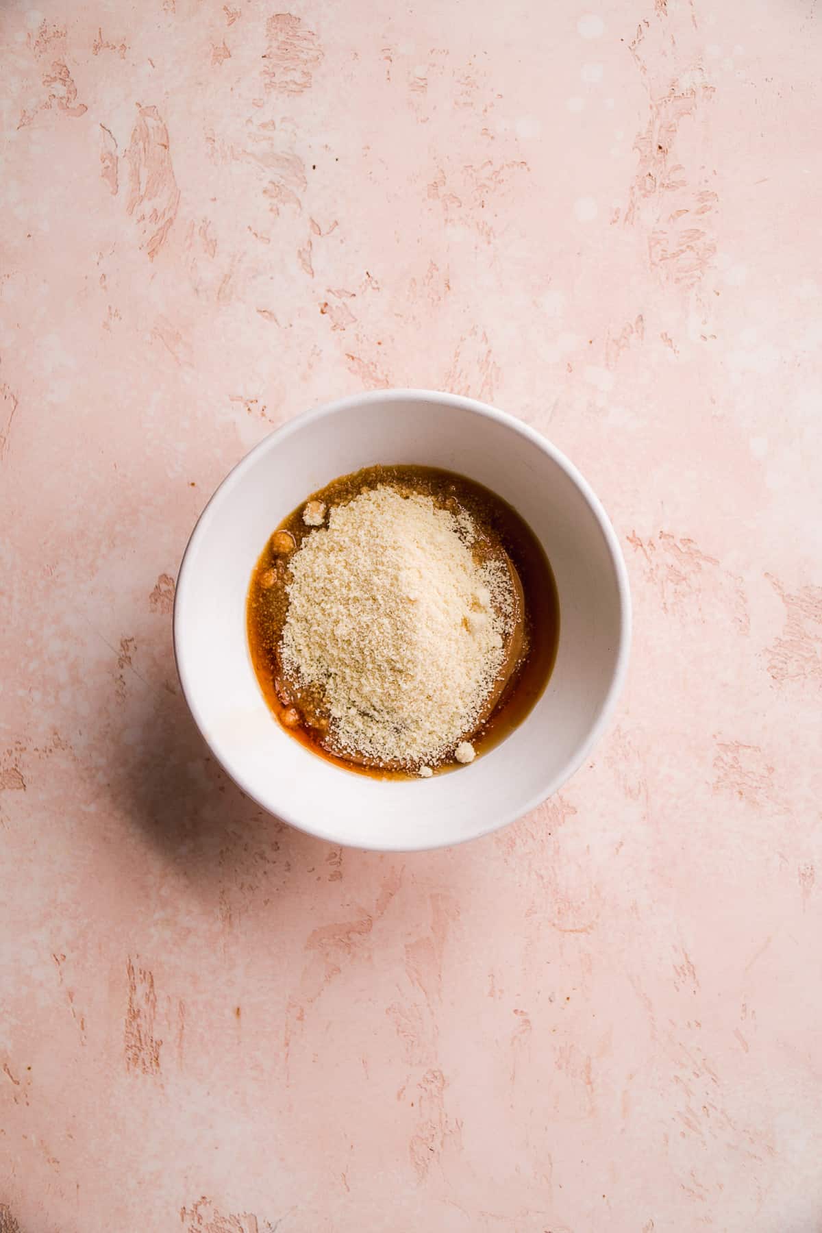 Overhead view of a bowl with peanut butter filling ingredients about to me mixed.