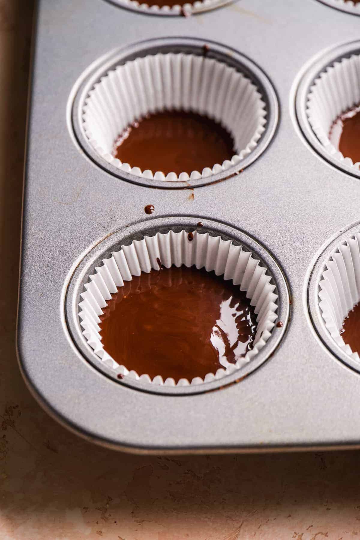 Cupcake liners filled with dark chocolate.