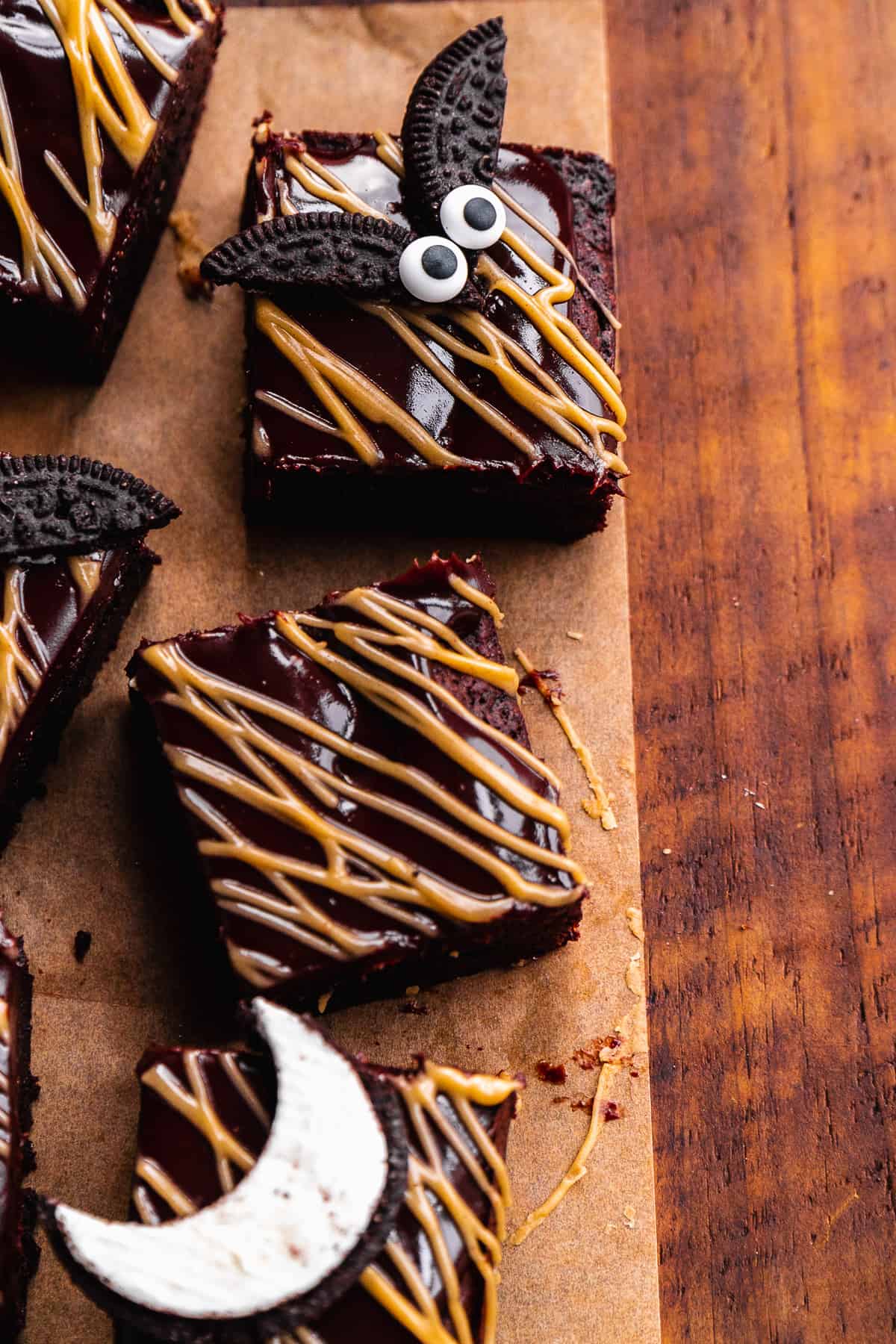 Brownie squares with almond butter drizzled over top with Oreo bat on top.