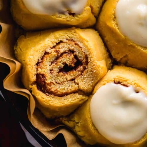 Overhead view of pumpkin cinnamon rolls in a pan.