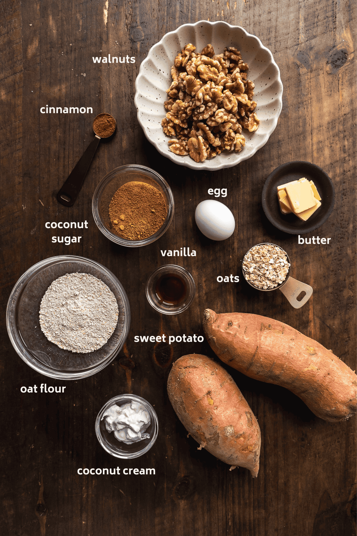 Sweet potato casserole ingredients on a wooden surface with labels in white.