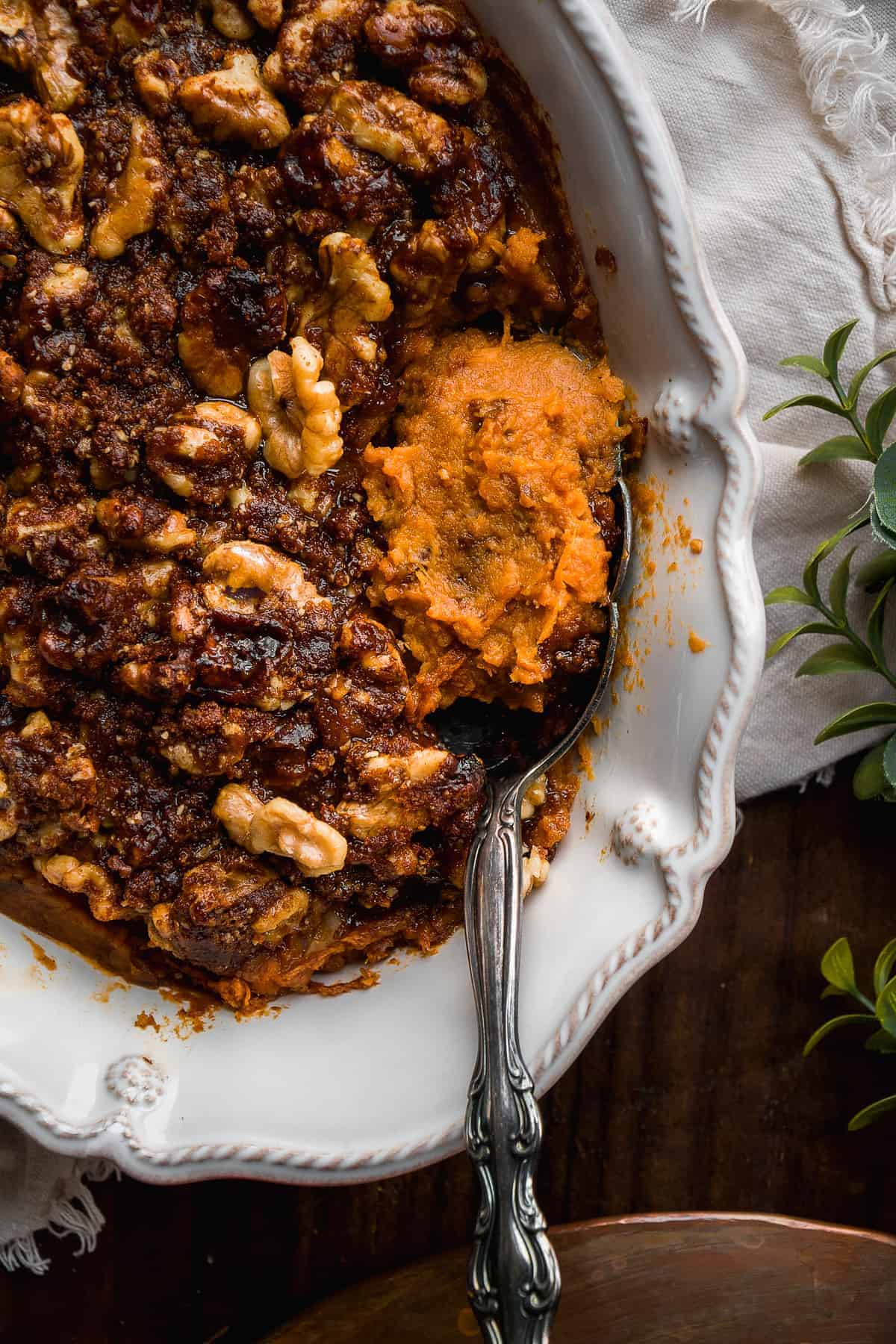 Overhead view of a sweet potato casserole with a spoon resting inside.