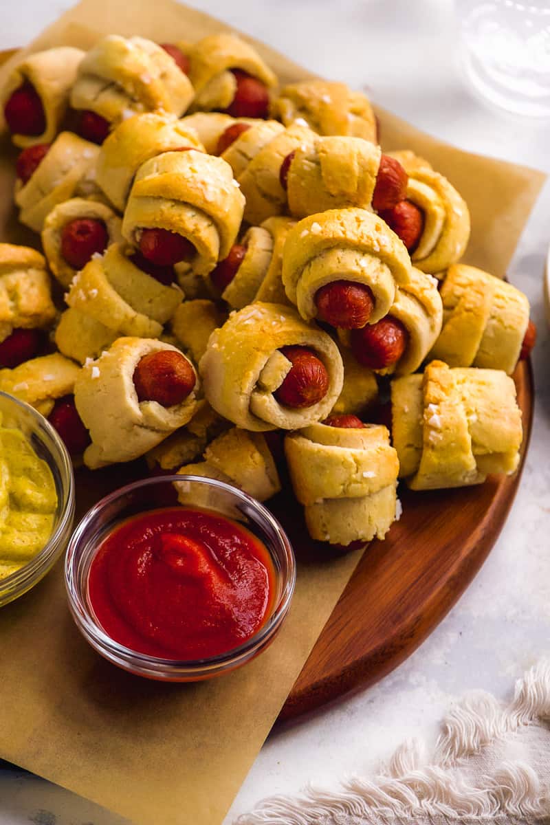 Gluten free pigs in a blanket piled on a platter.