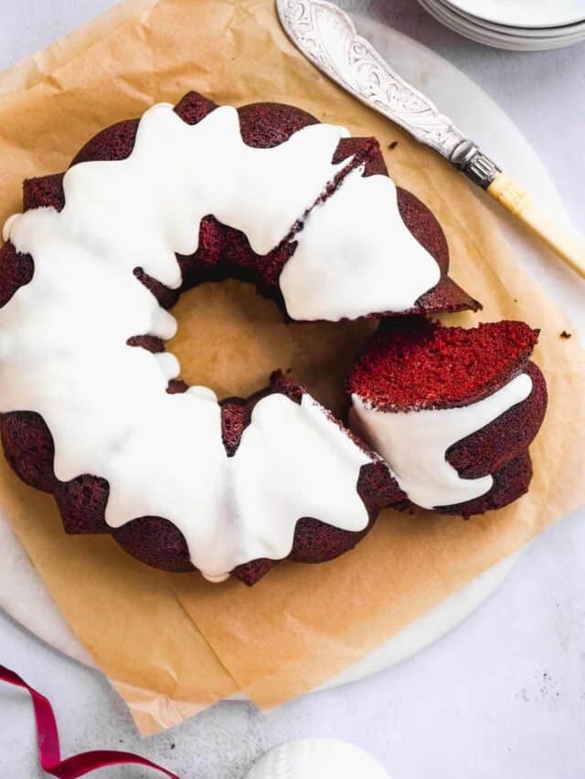 Aerial view of red velvet bundt cake on parchment paper.