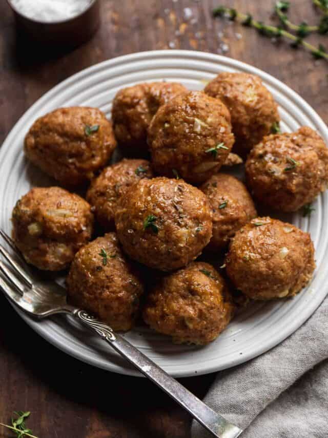 Gluten free turkey meatballs piled on a plate with a fork.