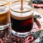 Chocolate white Russian being poured into a glass.