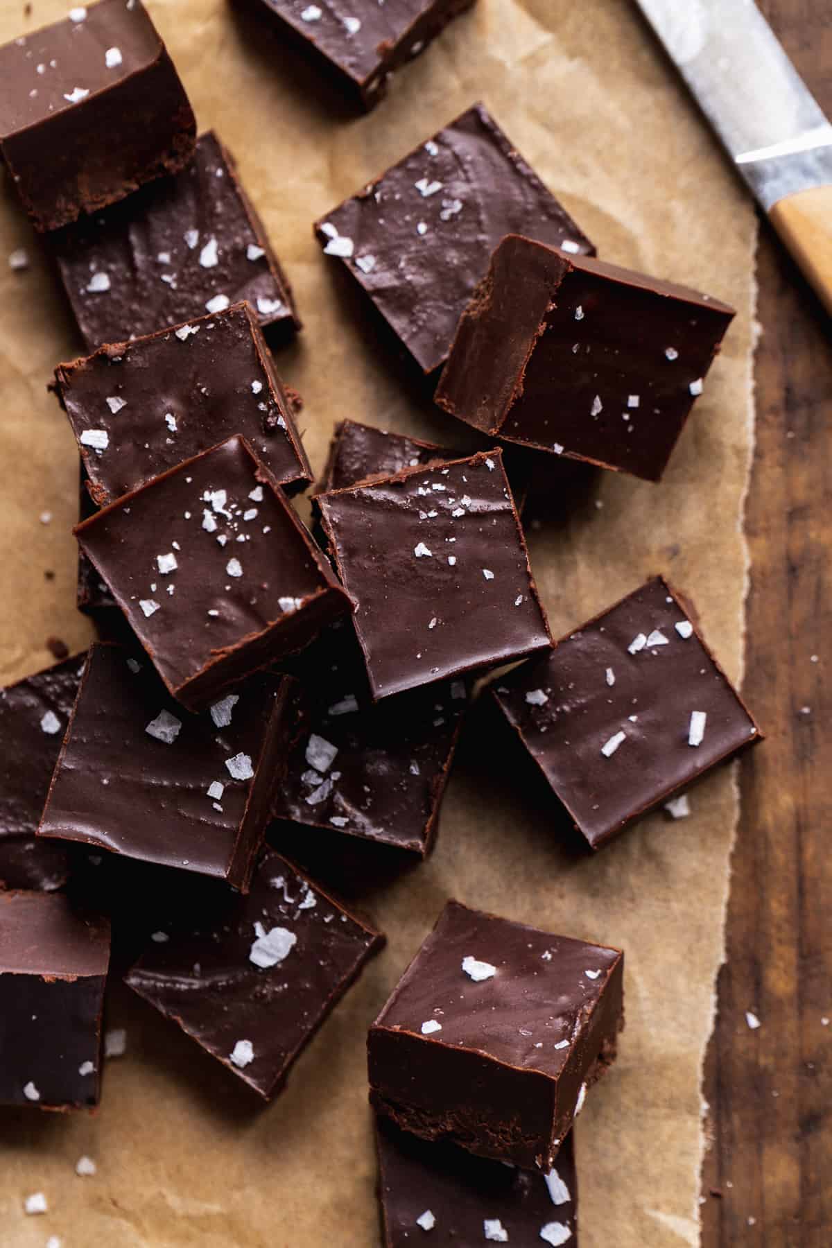 Vegan fudge cut into squares on parchment paper.