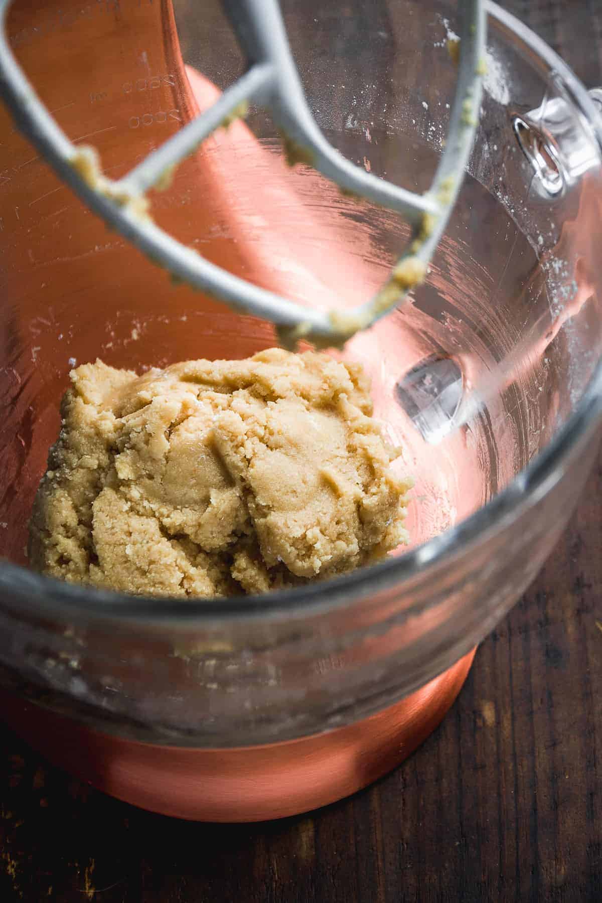 Sugar cookie dough in a glass mixing bowl.