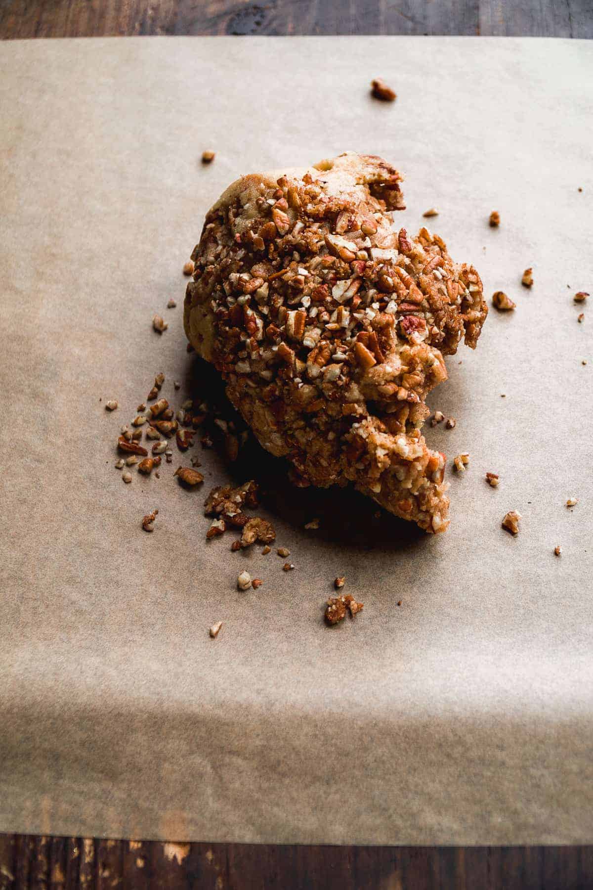 Cinnamon sugar cookie dough on a piece of parchment paper.